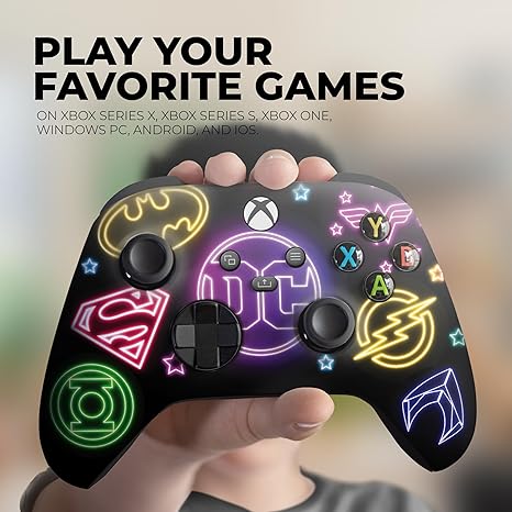 Neon DC Comics Xbox Series X controller in hand with glowing face-button layout