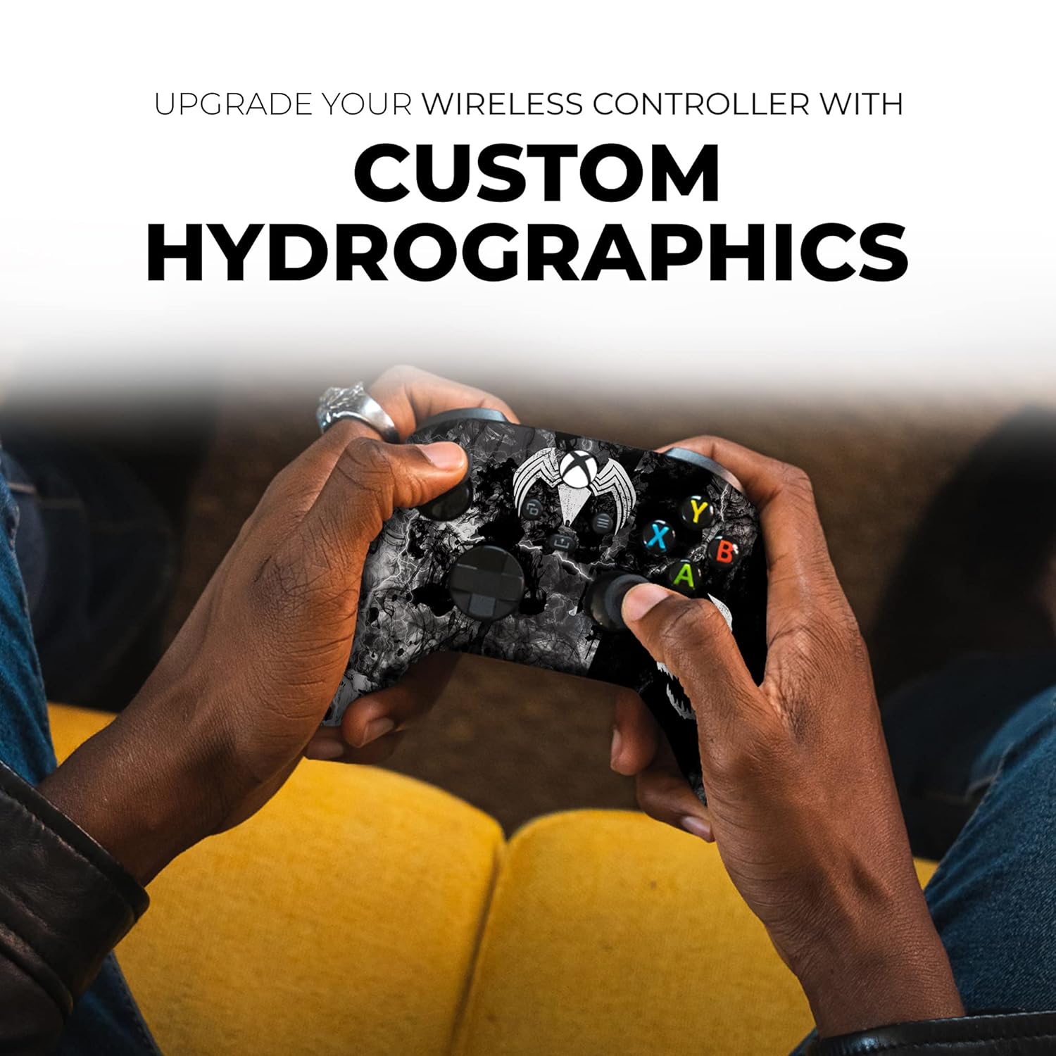 Hands holding black Xbox Series X wireless controller with Venom skull graphic and face buttons