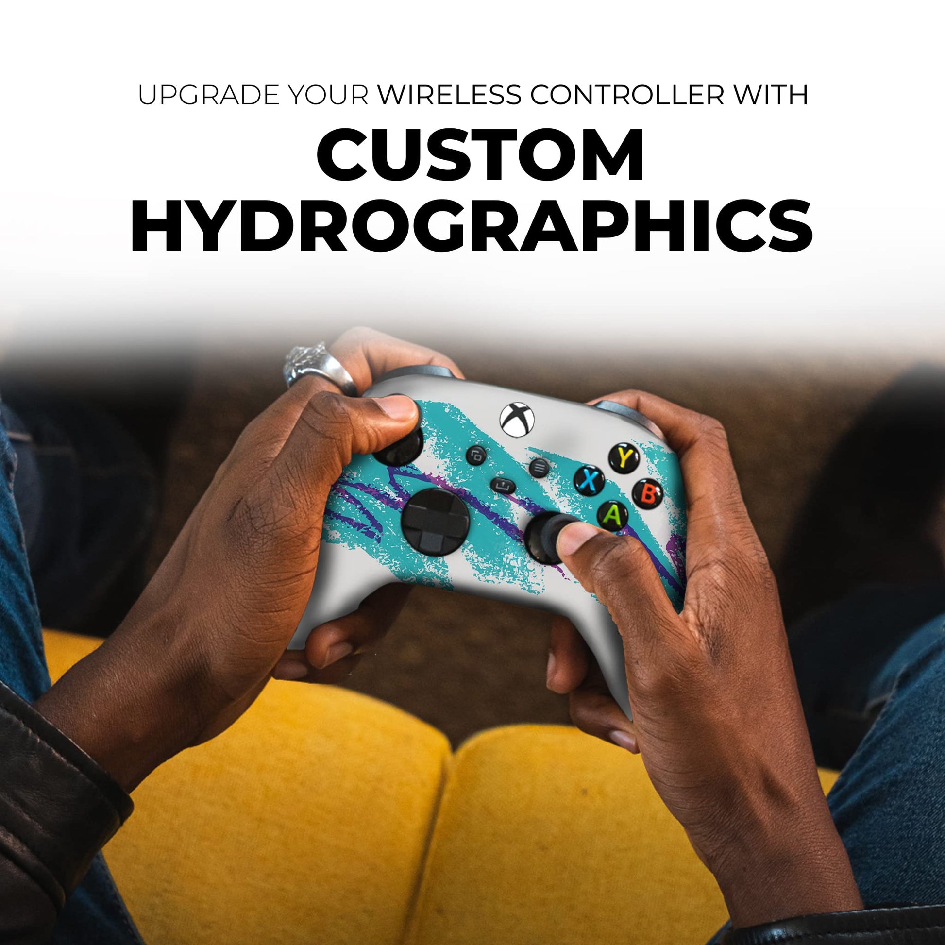 Xbox controller with teal custom graphics, held in hands