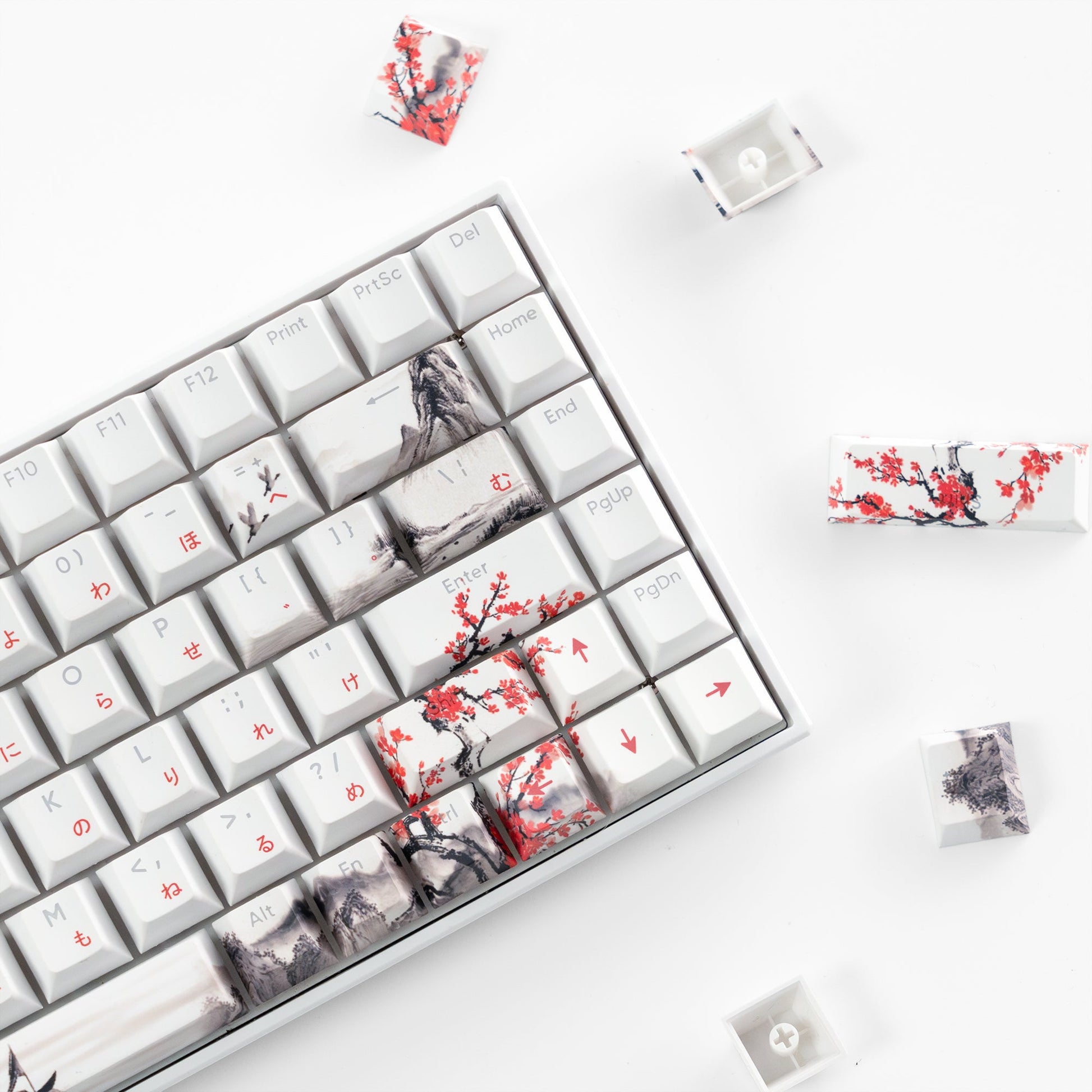 White keycaps with cherry blossom and skyline prints, close-up of engraved legends