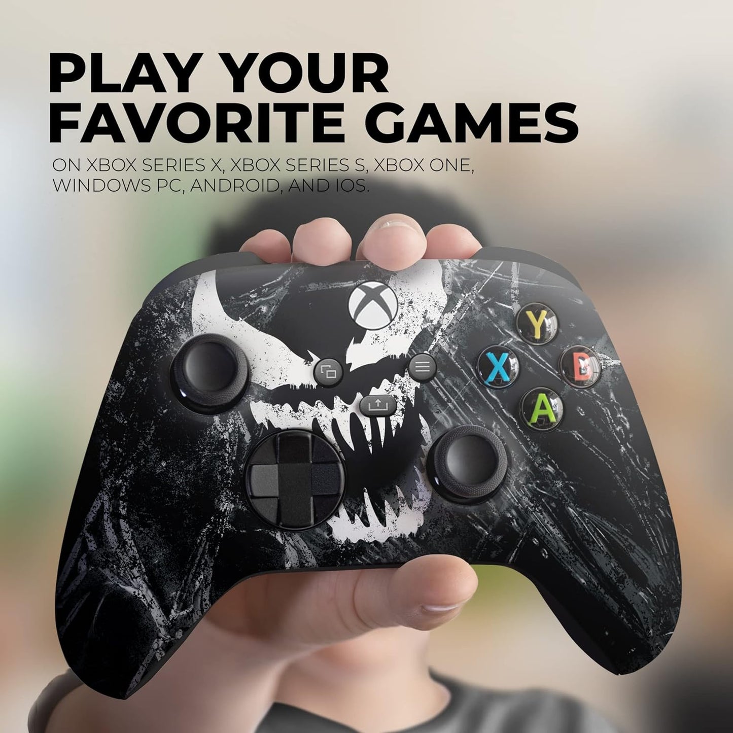 Black Xbox wireless controller held in hand, skull graphic and colored ABXY buttons visible