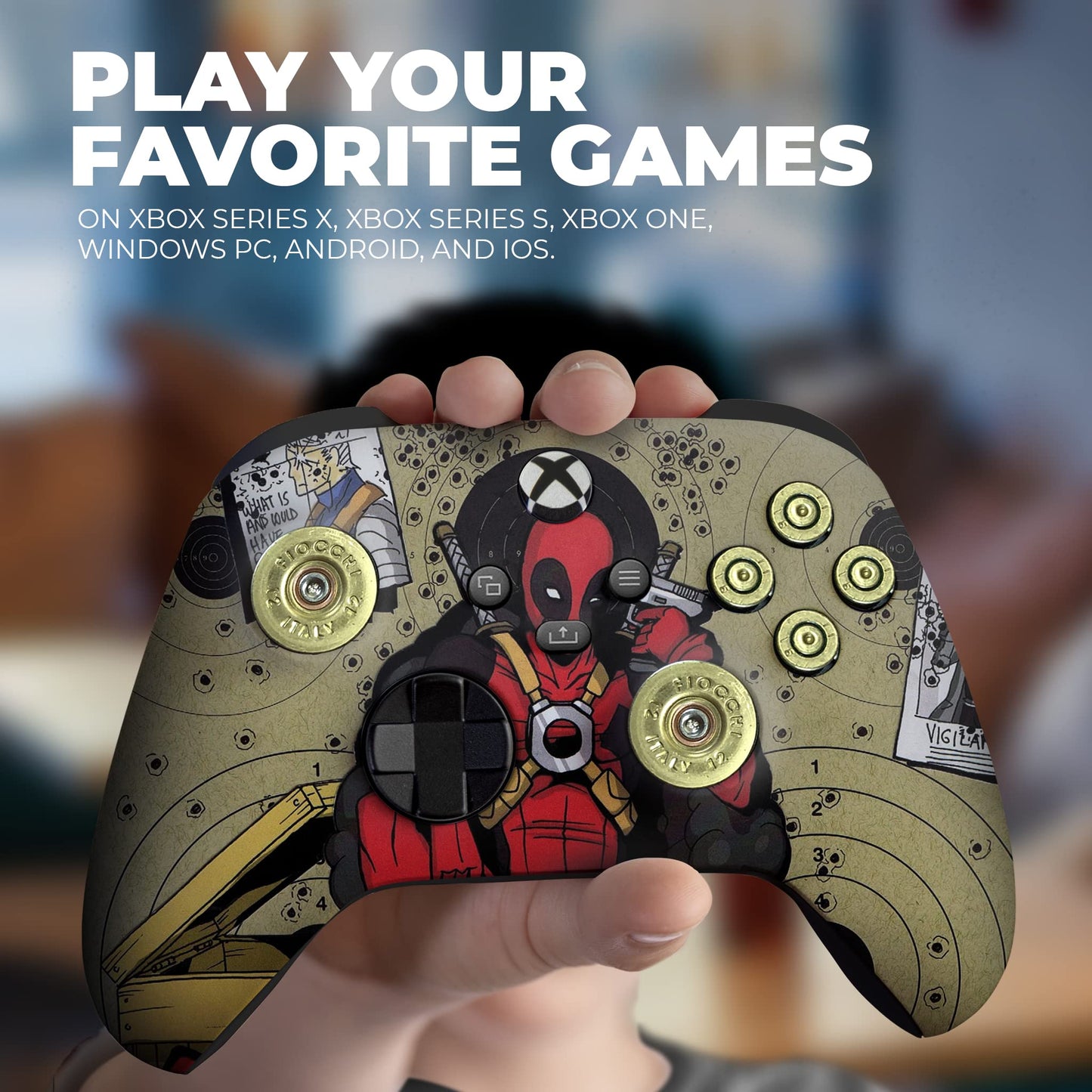 Hand holding olive gaming controller with red Deadpool headshot and gold thumbstick caps
