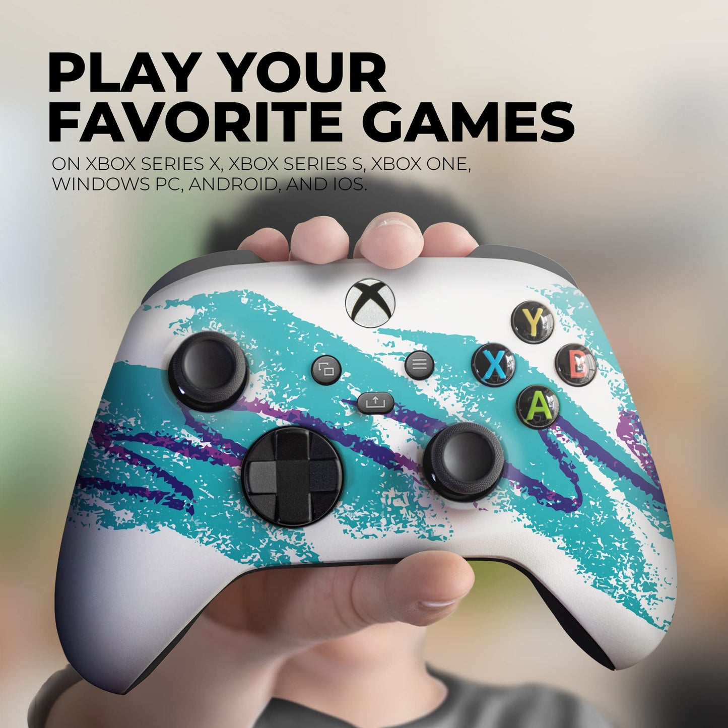 Xbox controller with teal splatter design in a hand
