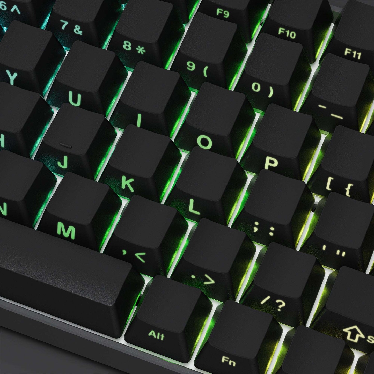 Close-up keycaps with side-printed letters, dark caps with green backlight accents