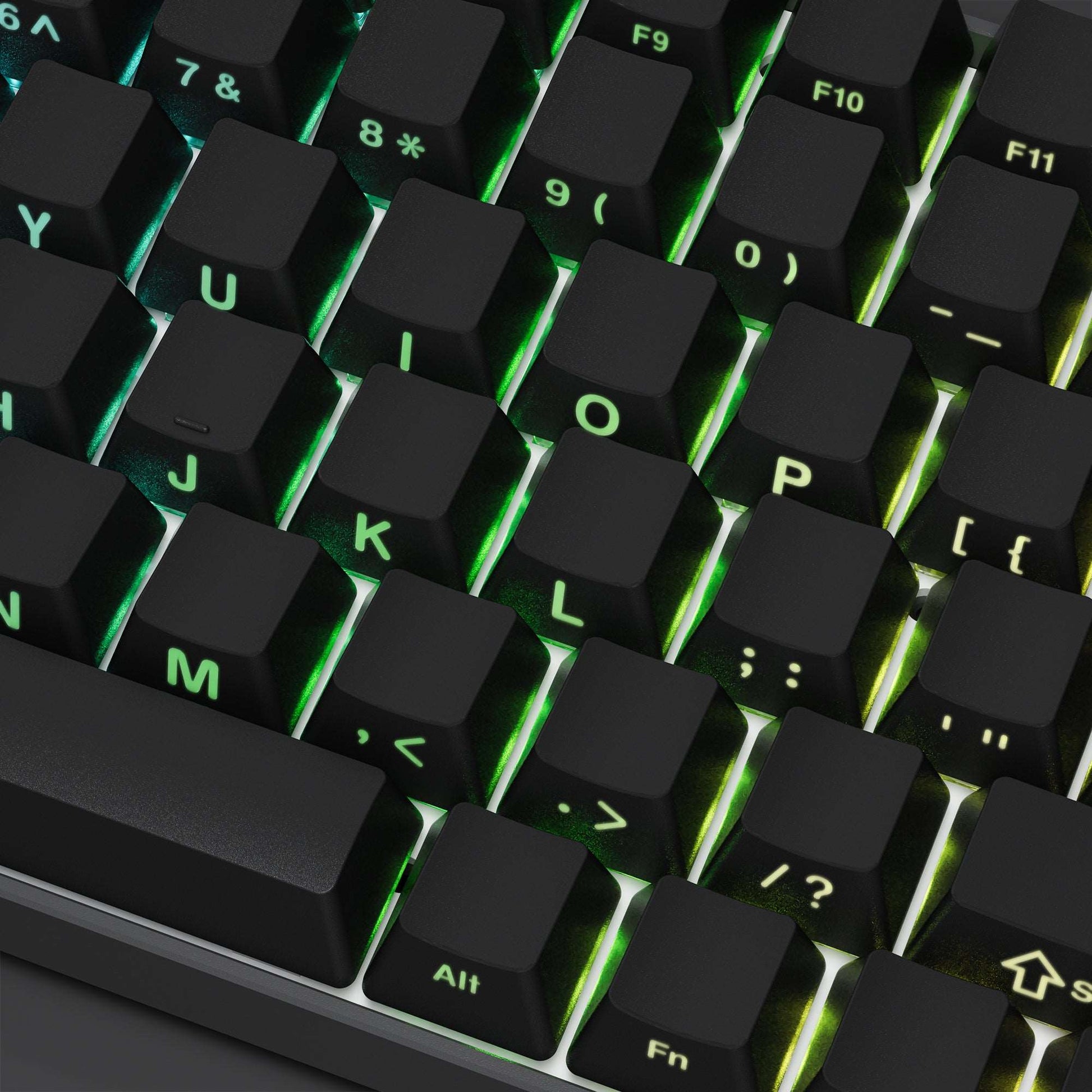 Close-up keycaps with side-printed letters, dark caps with green backlight accents