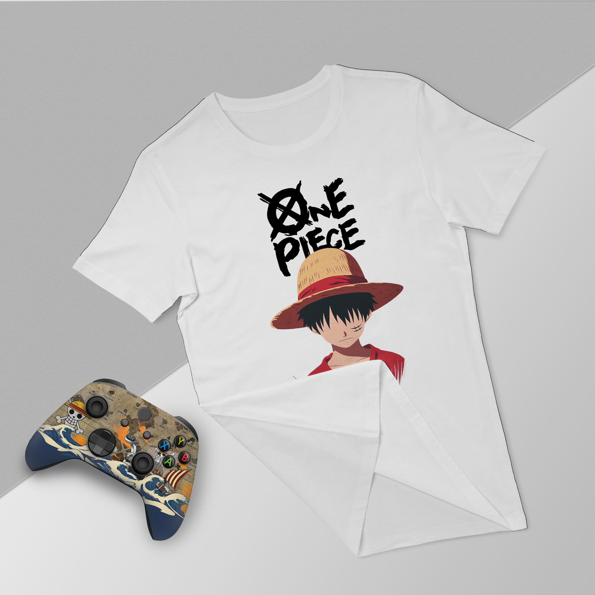 White graphic T-shirt and Xbox controller bundle with One Piece character print