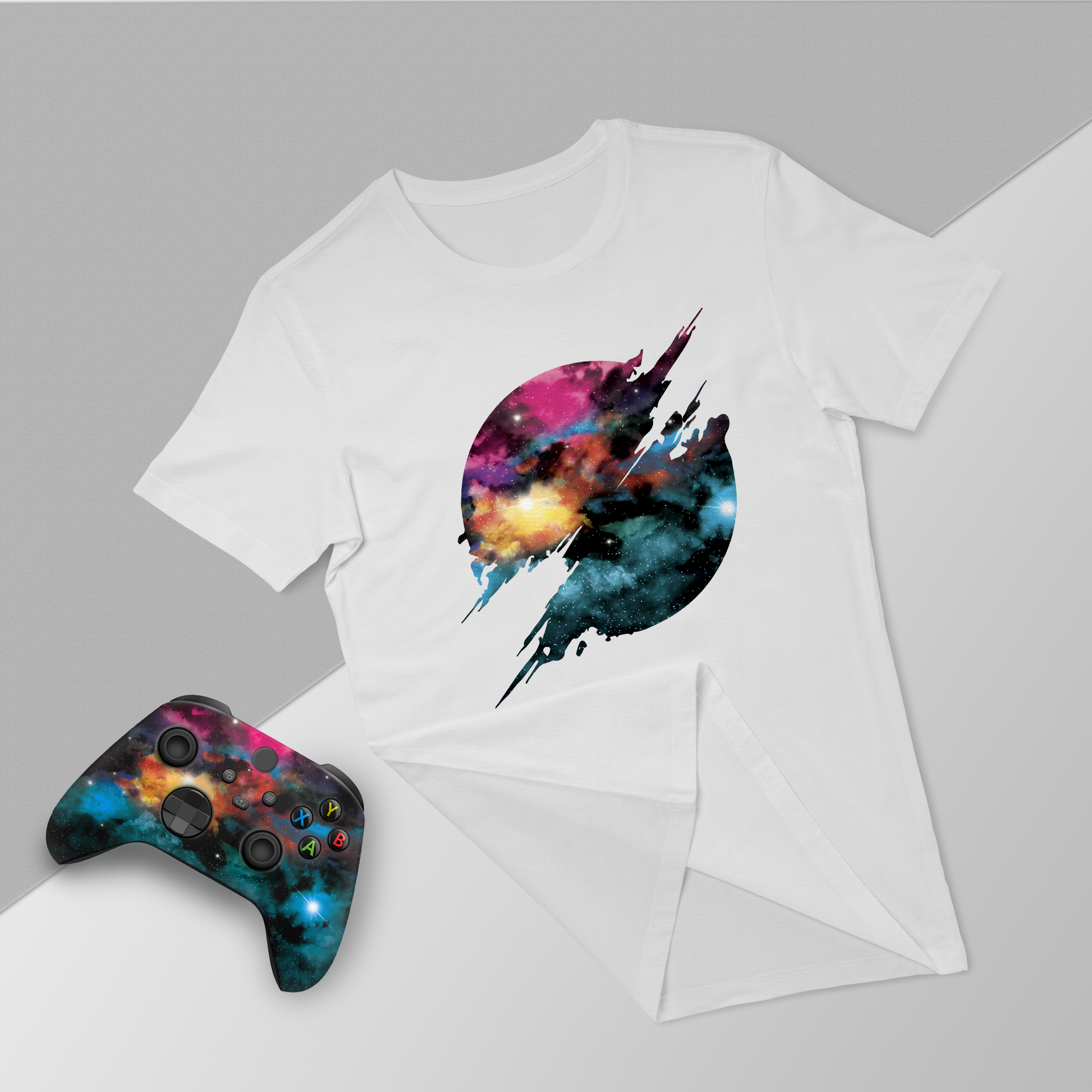 White T-shirt with galaxy jet graphic, with Xbox Series X controller and folded tee