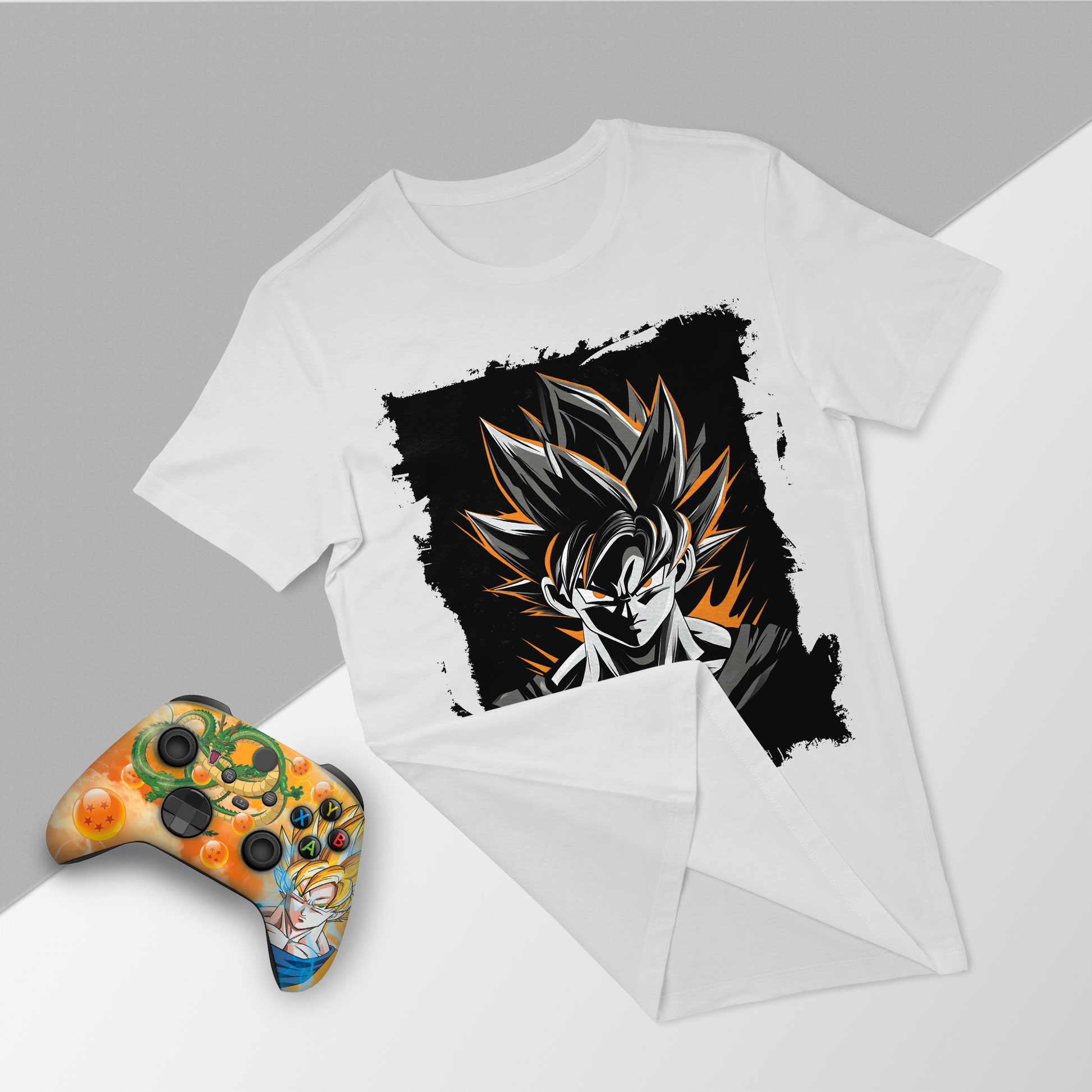 White graphic t-shirt and orange themed Xbox controller, flat lay front view