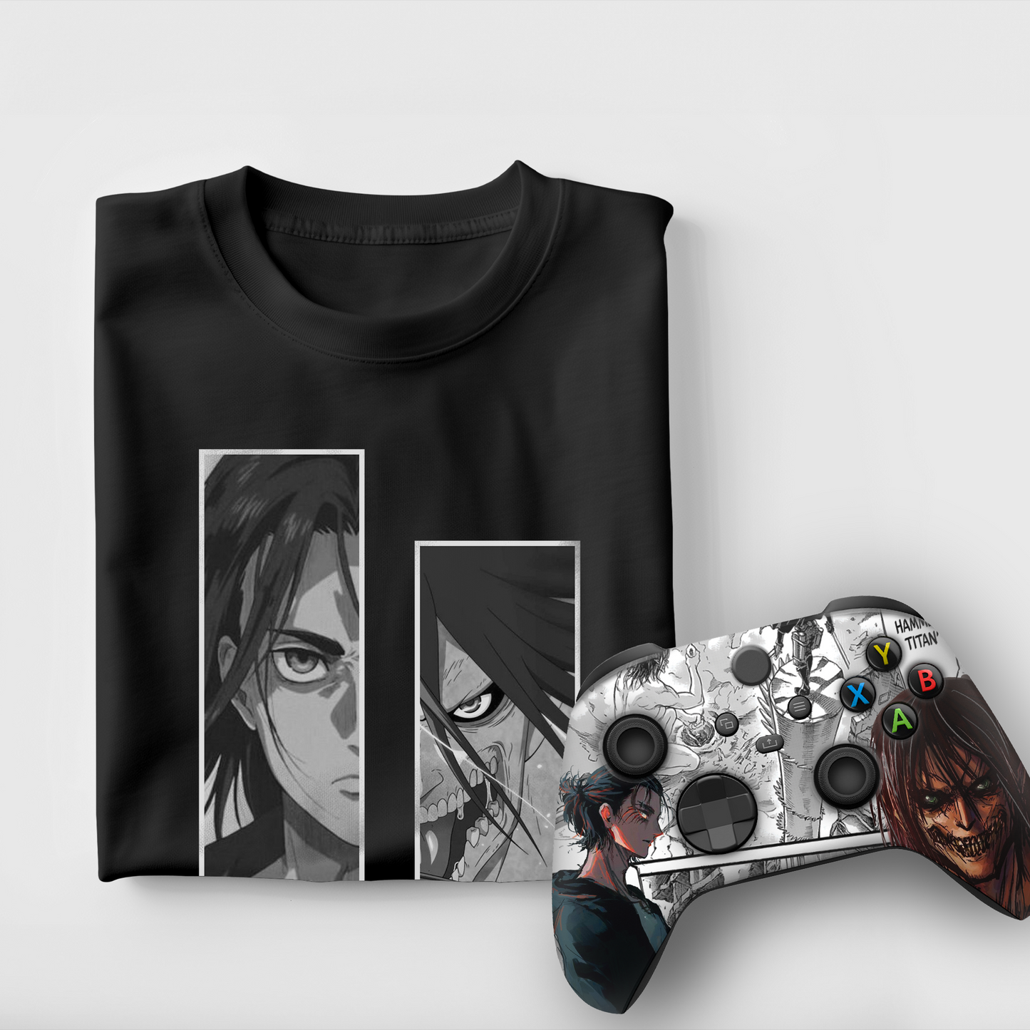 Black graphic T-shirt with two portrait panels and Xbox controller with colorful buttons