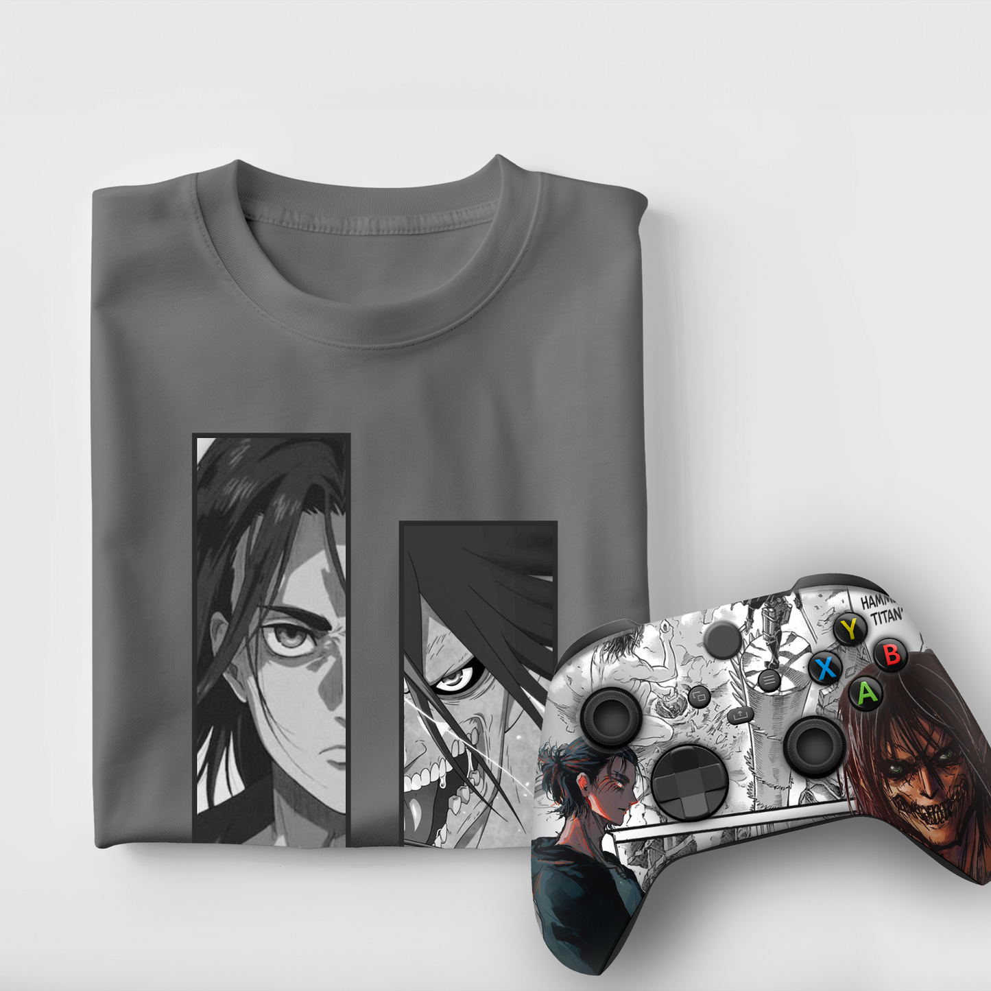 Gray graphic T-shirt with anime panels; silver Xbox-style controller with themed decals