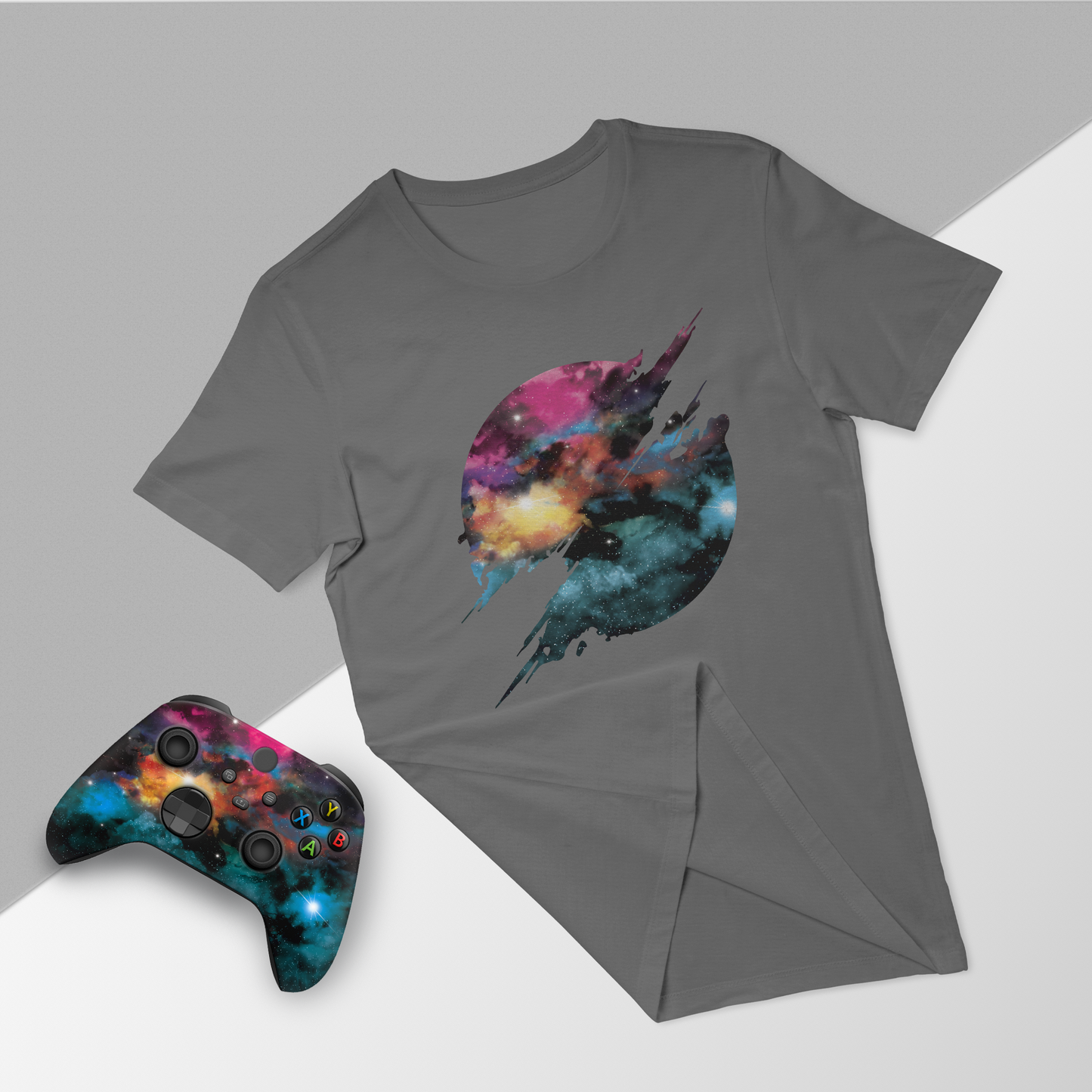 Gray T-shirt with galaxy jet graphic, paired with Xbox Series X controller and folded tee