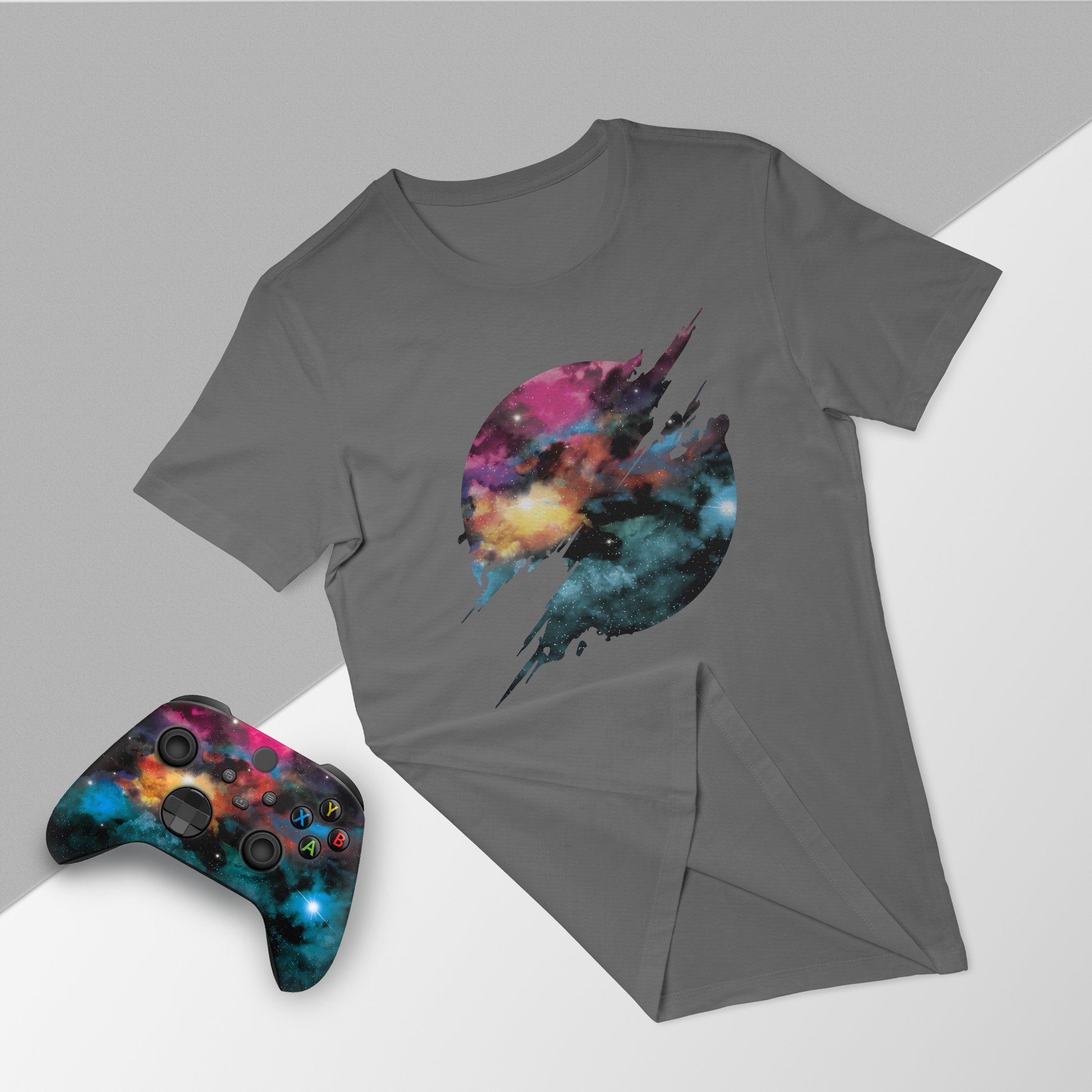 Gray T-shirt with galaxy jet graphic, paired with Xbox Series X controller and folded tee
