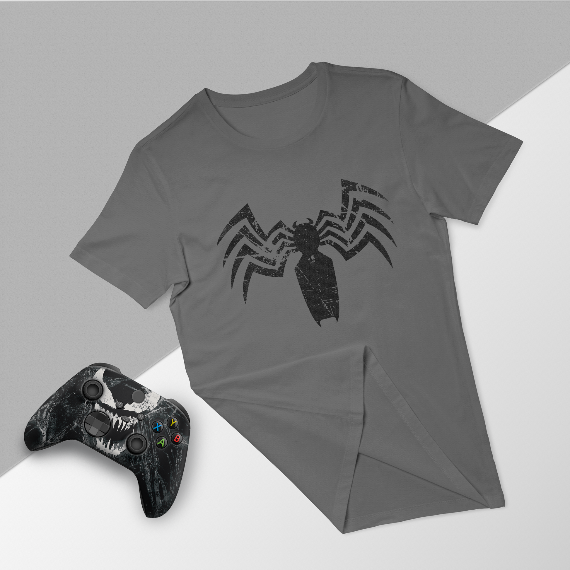 Gray venom graphic t-shirt with black Xbox controller, folded