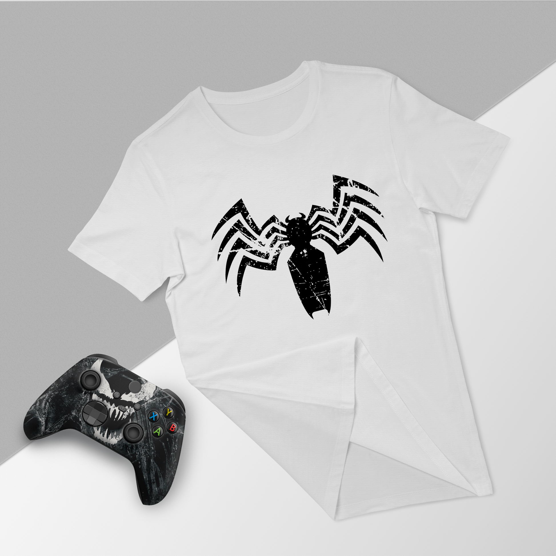 White venom graphic t-shirt with black Xbox controller, folded