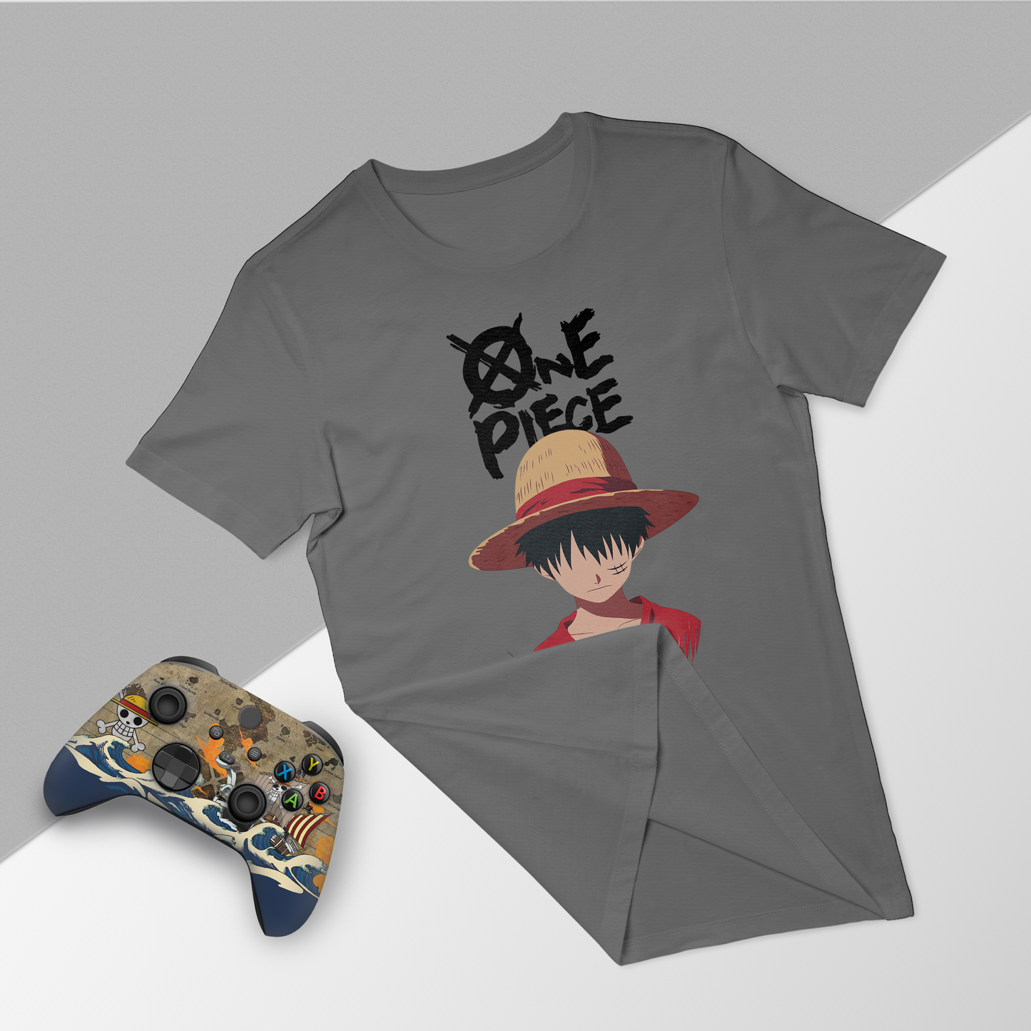 Gray graphic T-shirt and Xbox controller bundle with One Piece character-themed wave decals