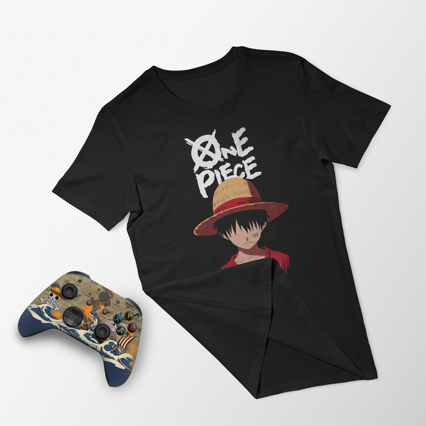 Black crewneck T-shirt with front character print; matching Xbox controller beside it.
