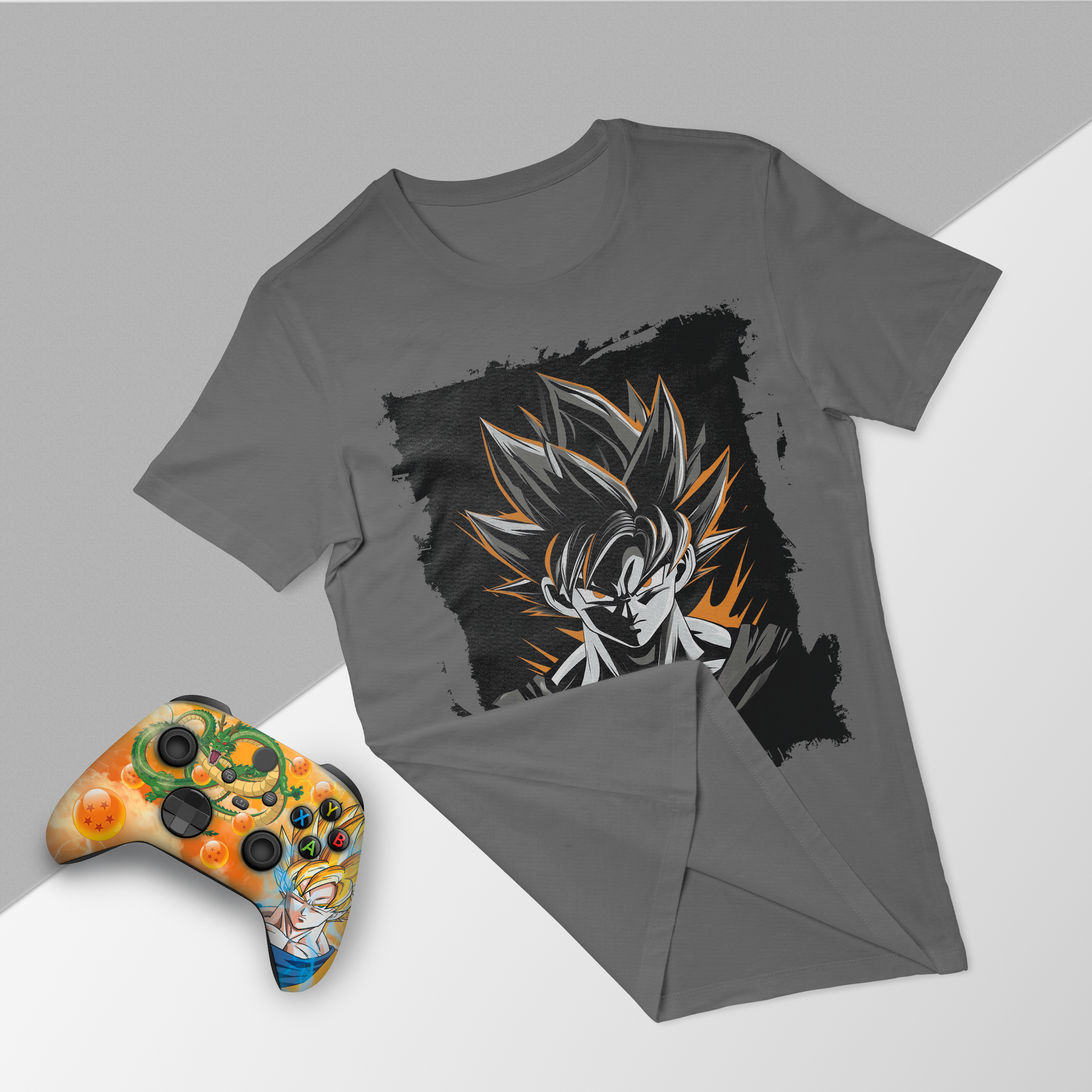 Gray graphic t-shirt and orange themed Xbox controller, flat lay front view