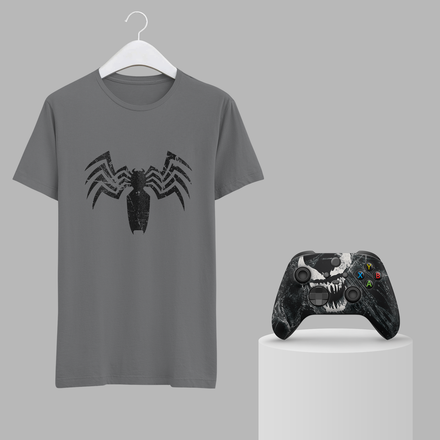 Gray venom graphic t-shirt on hanger with black Xbox controller
