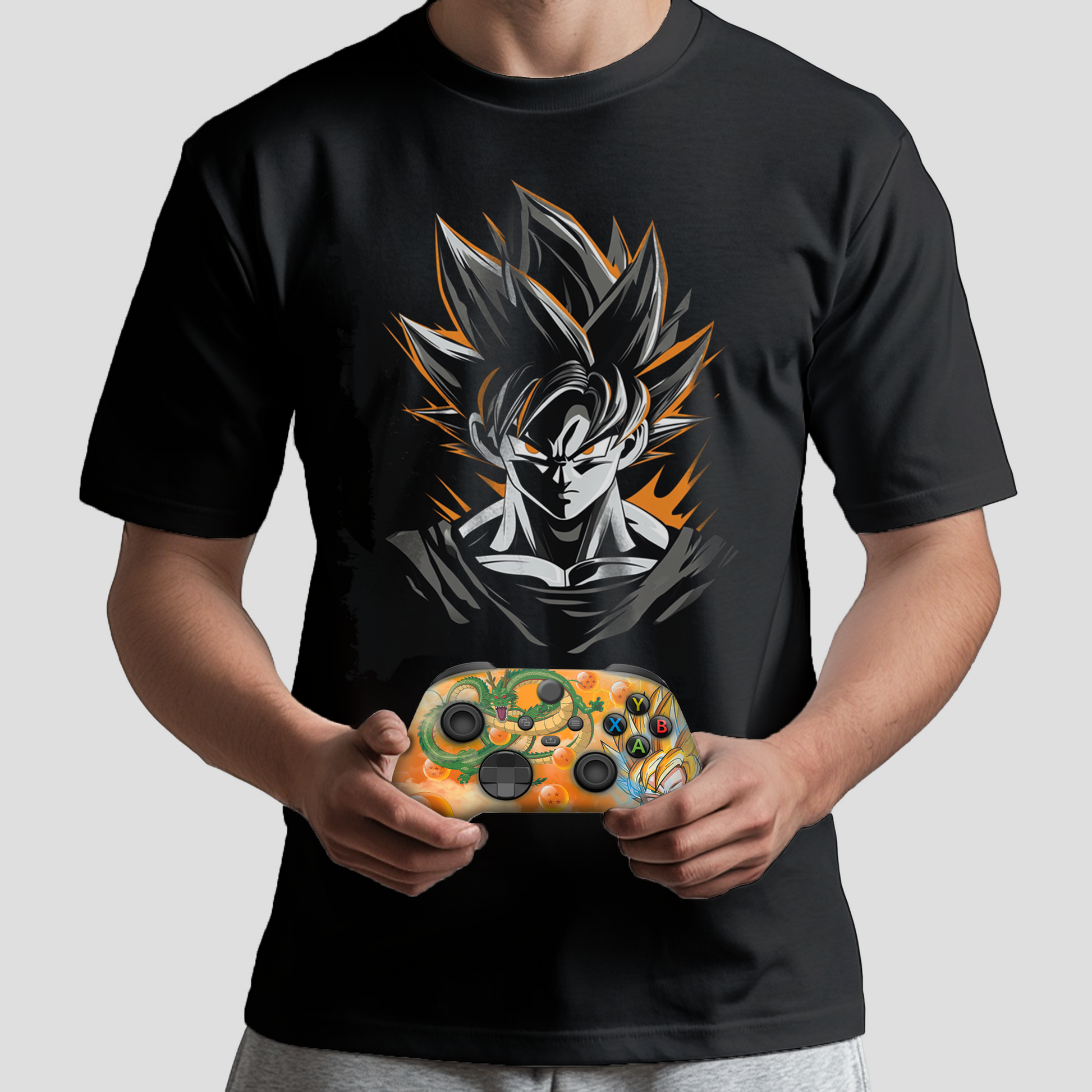 Black Goku graphic T-shirt held with decorated Xbox controller