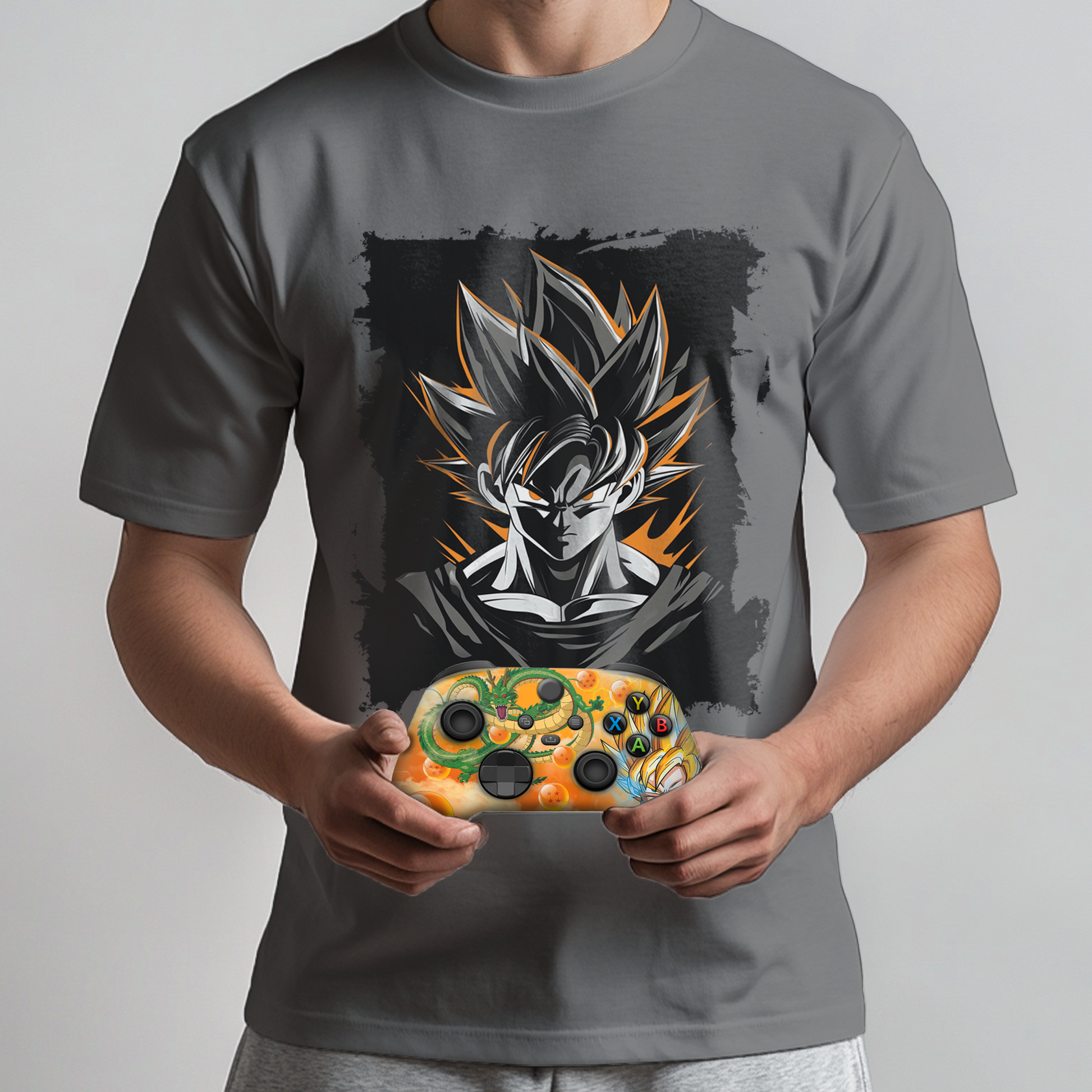 Gray graphic t-shirt with Goku chest print; orange themed Xbox controller in hands