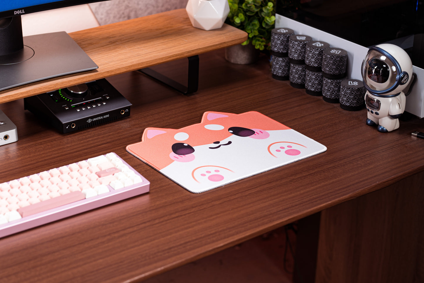 Shiba dog desk mat on wooden desk with pink paw icons and keyboard nearby