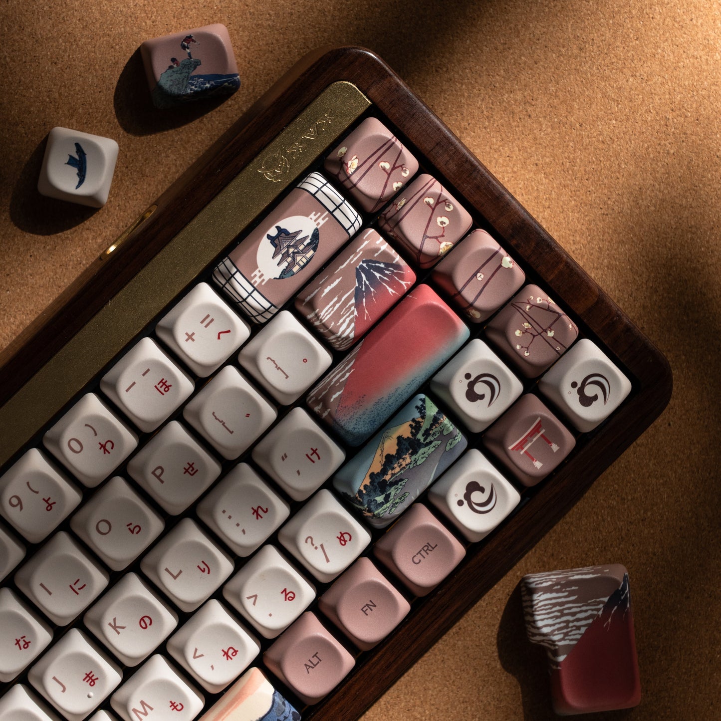 Close-up keycap set with cream keys, dark accents, and landscape-style printed caps
