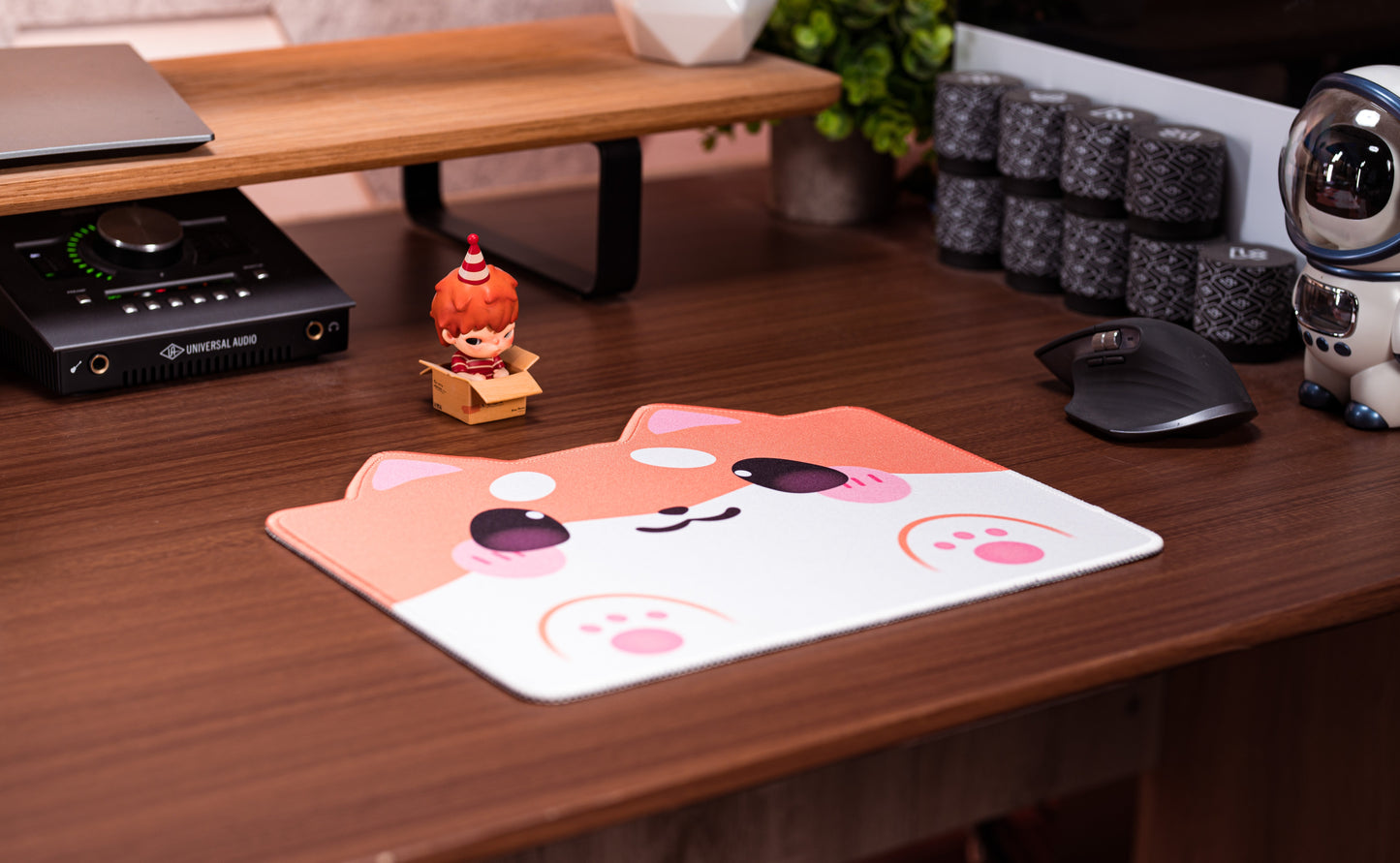 Shiba dog desk mat on wooden desk with cartoon dog face and paw-print graphics