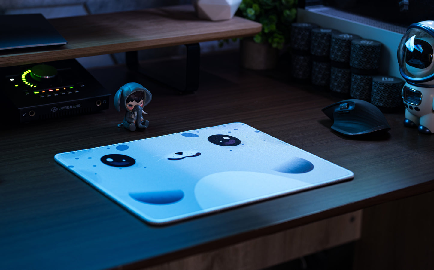 Seal-pattern desk mat on wooden desk, light blue with dark seal eyes and nose