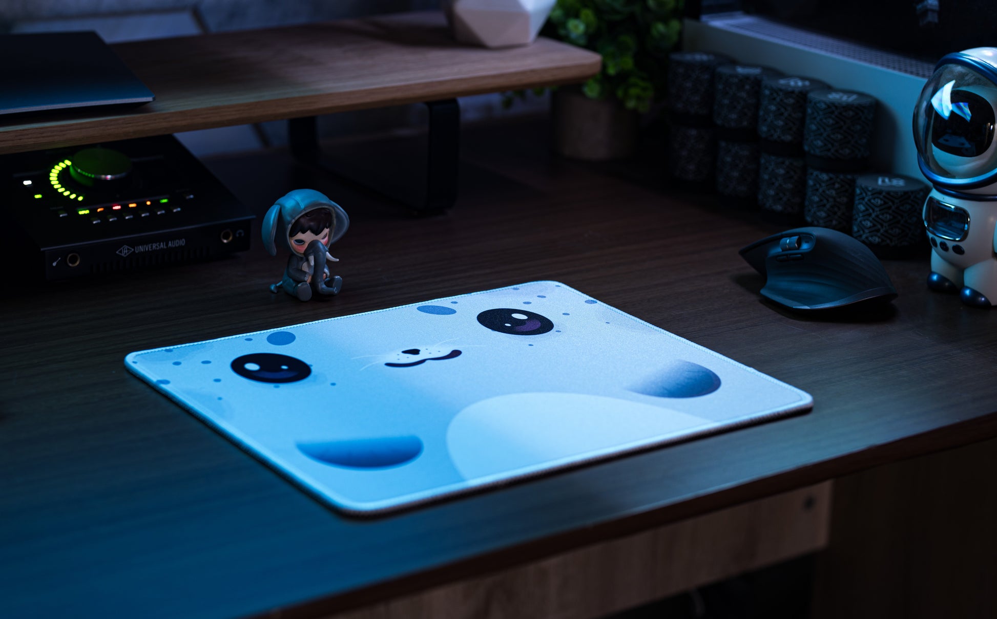 Seal-pattern desk mat on wooden desk, light blue with dark seal eyes and nose
