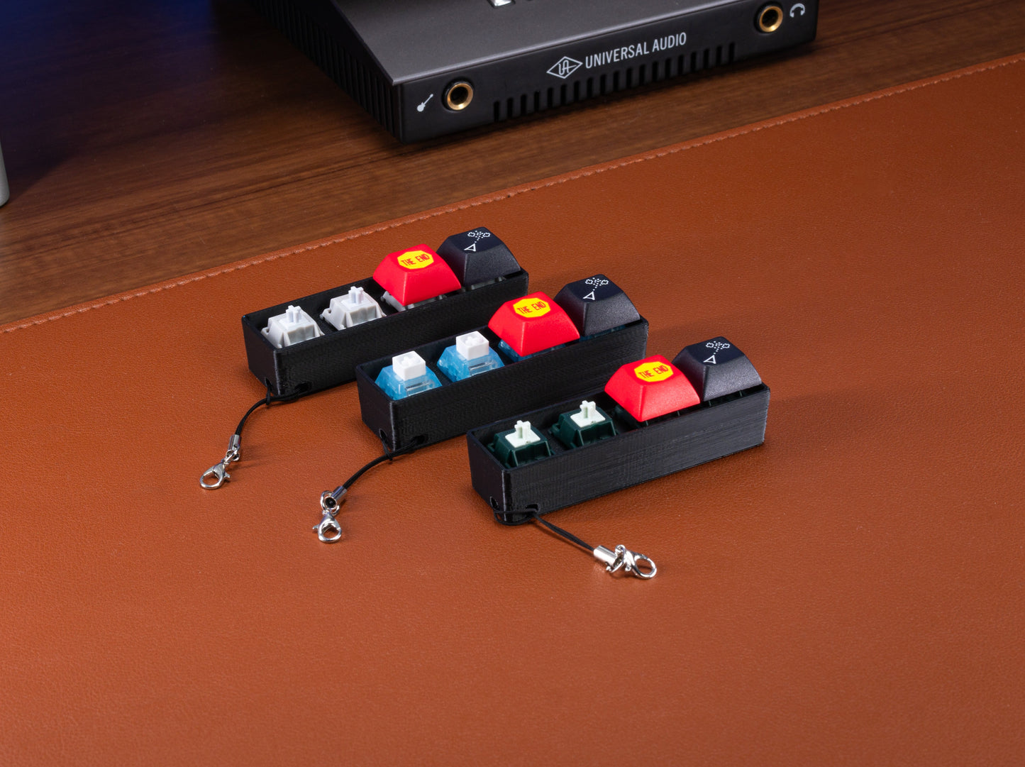 Atari Keycap Fidget set of three colorways with red keycaps and keychains