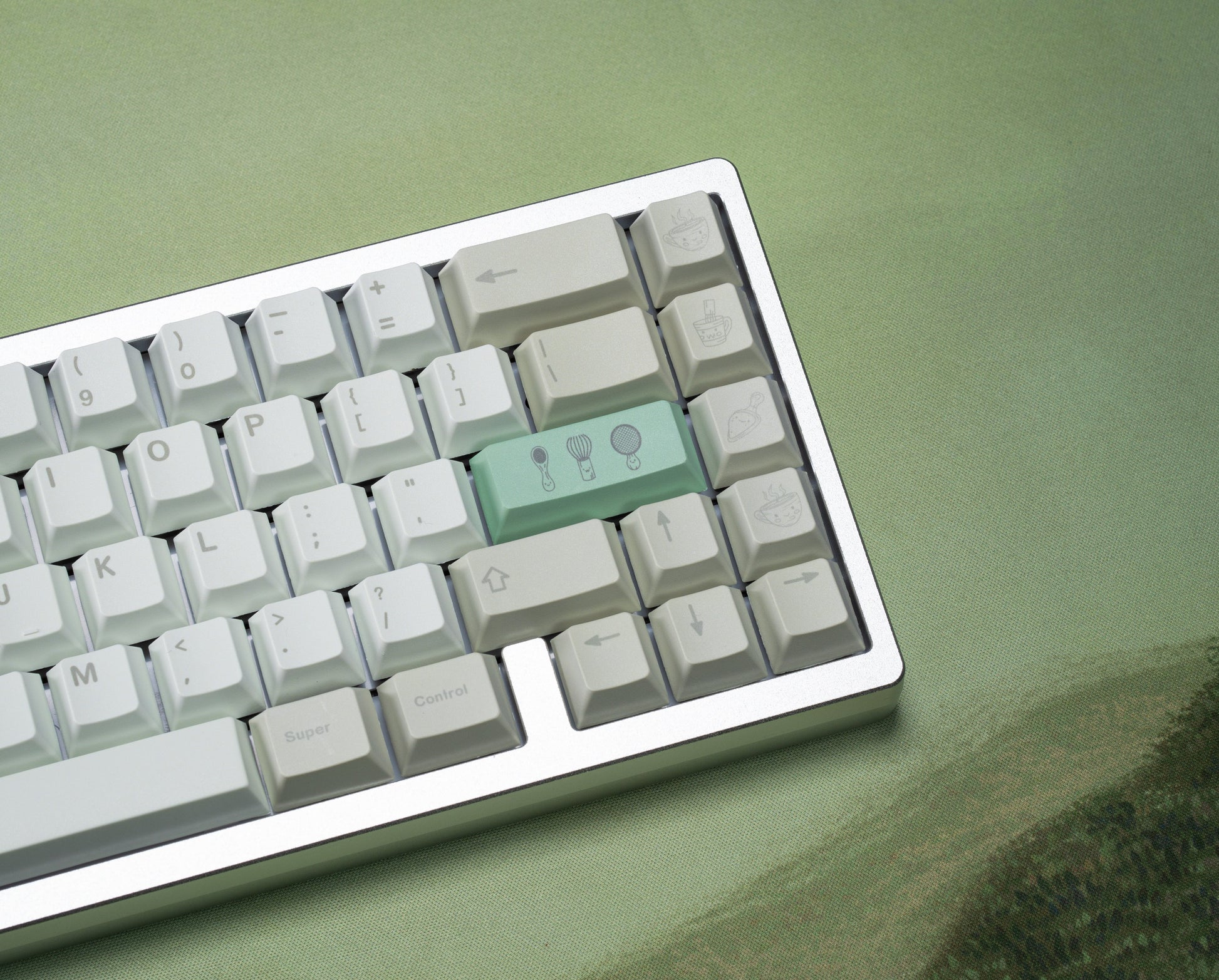 Close-up keyboard keycaps with white keys and mint-green control cluster