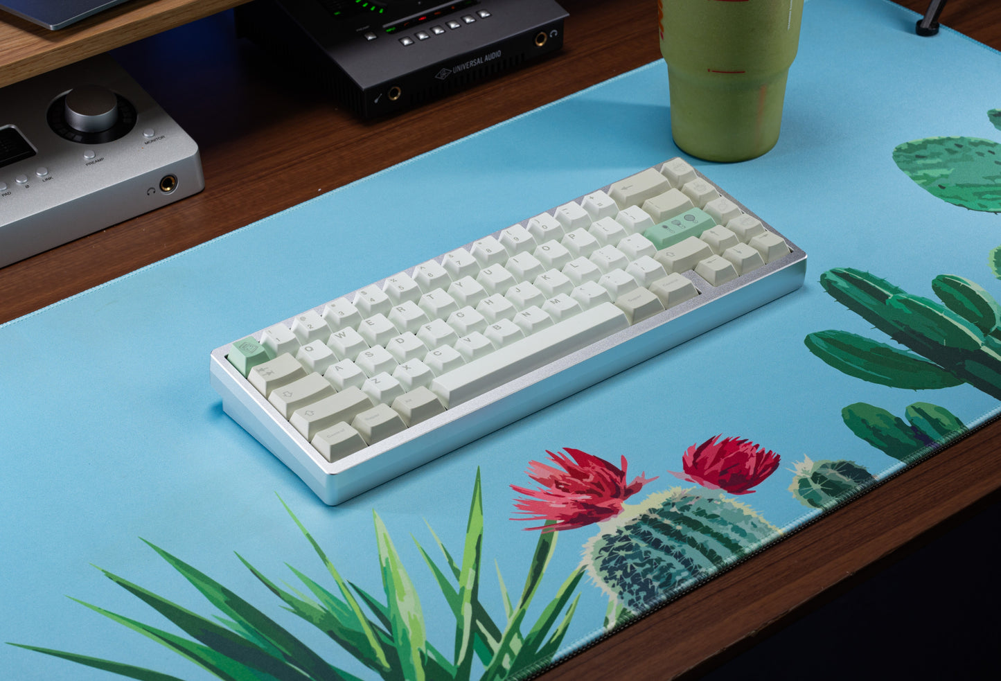 Keyboard keycaps with white rows and mint-green accent keys, on a flat keyboard base