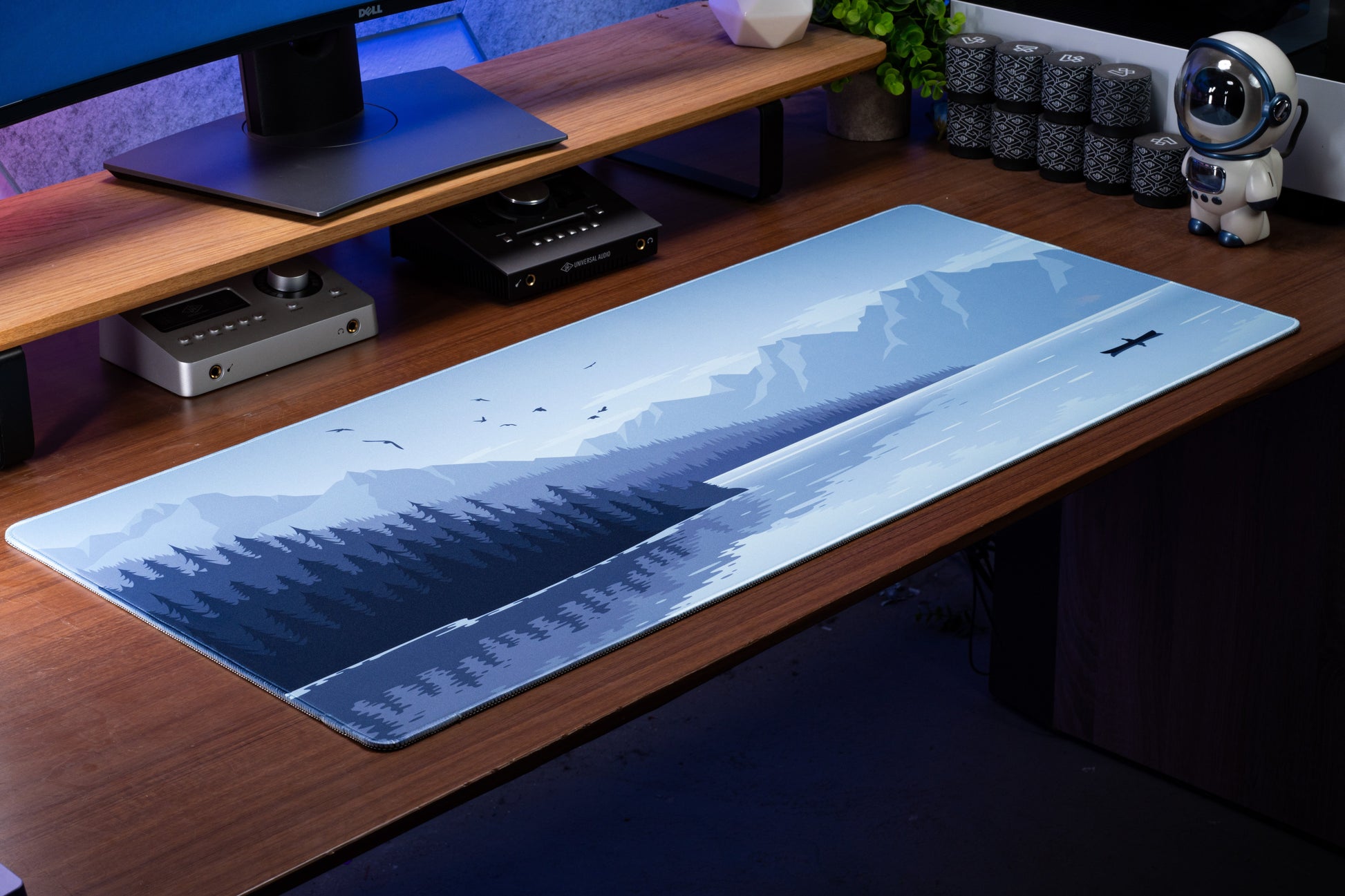 Blue landscape desk mat with airplane graphic and snowy hills, rectangular edges