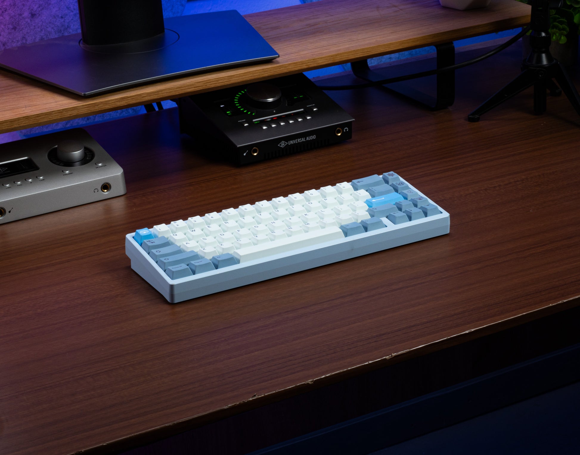 Light-blue and white PBT keyboard keycaps with dark legends, angled desk view