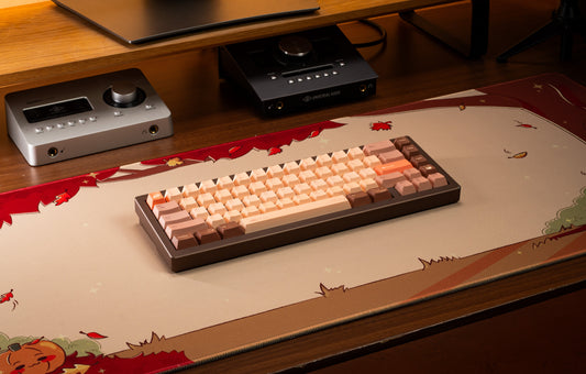Keyboard with beige and orange pumpkin-themed keycaps arranged in rows
