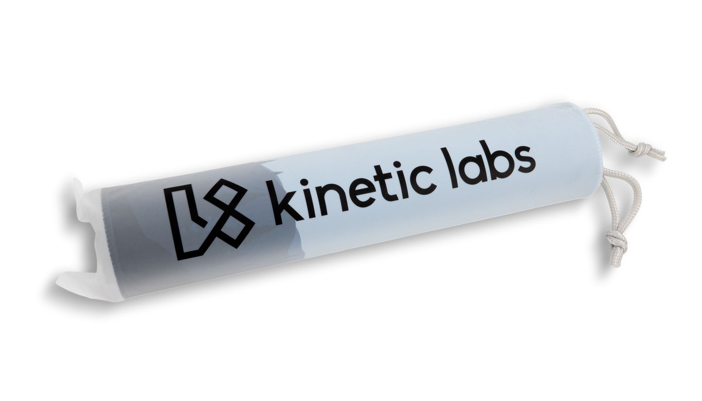 Rolled desk mat with 'kinetic labs' logo sleeve and drawstring cords