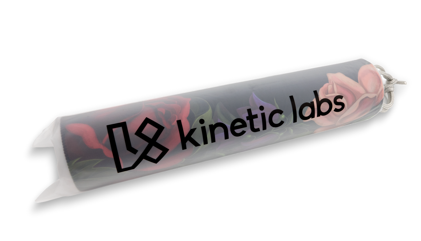 Rolled desk mat with Kinetic Labs logo and pink flower print