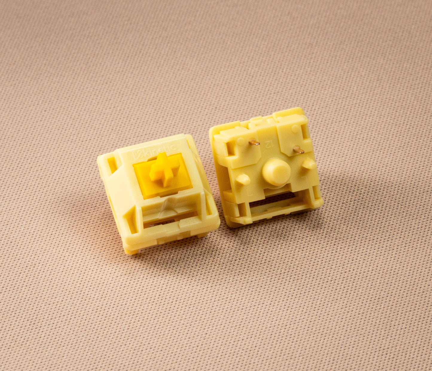Pair of HMX Butter linear switches, cream housings with exposed yellow stem