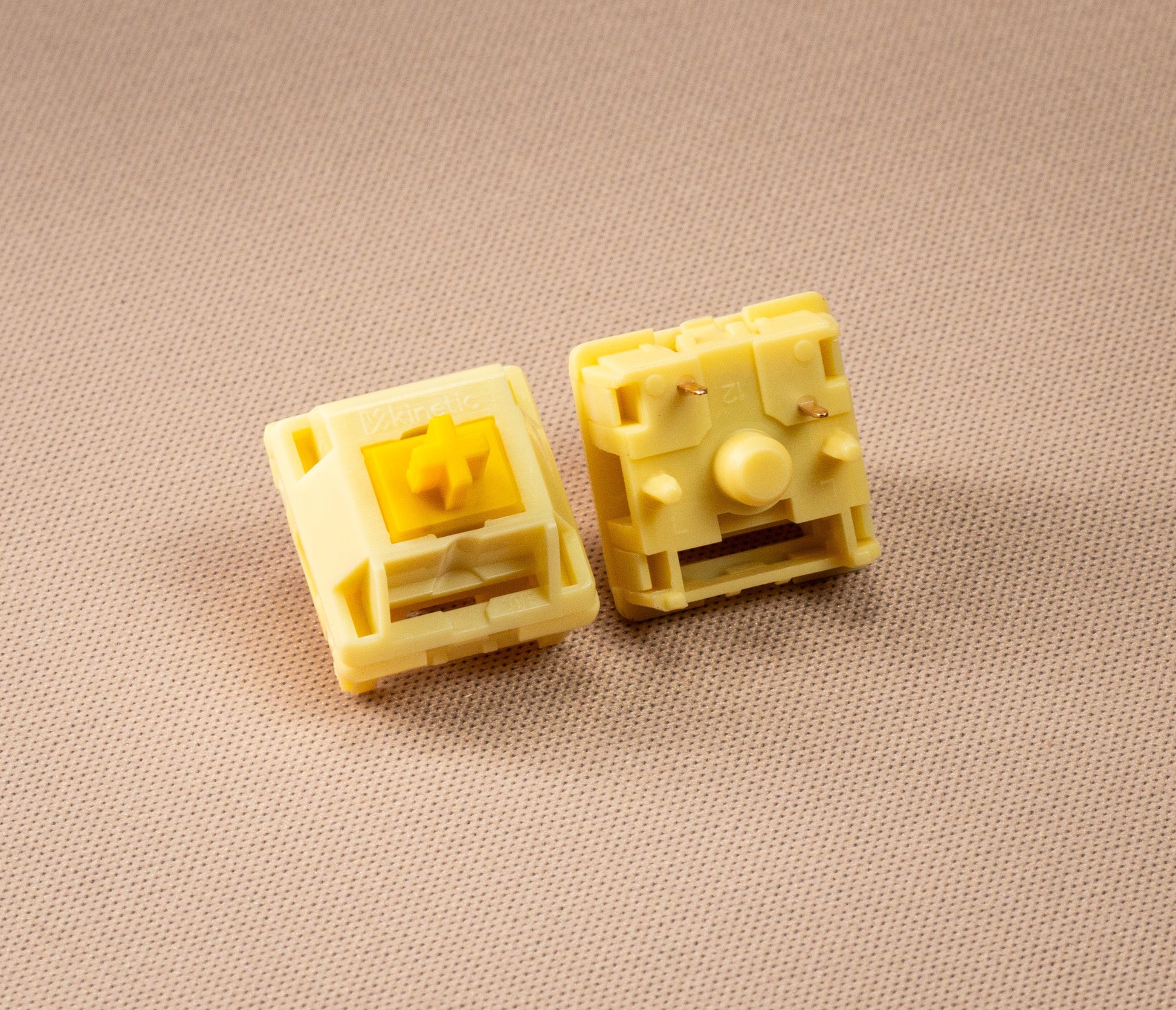 Pair of HMX Butter linear switches, cream housings with exposed yellow stem