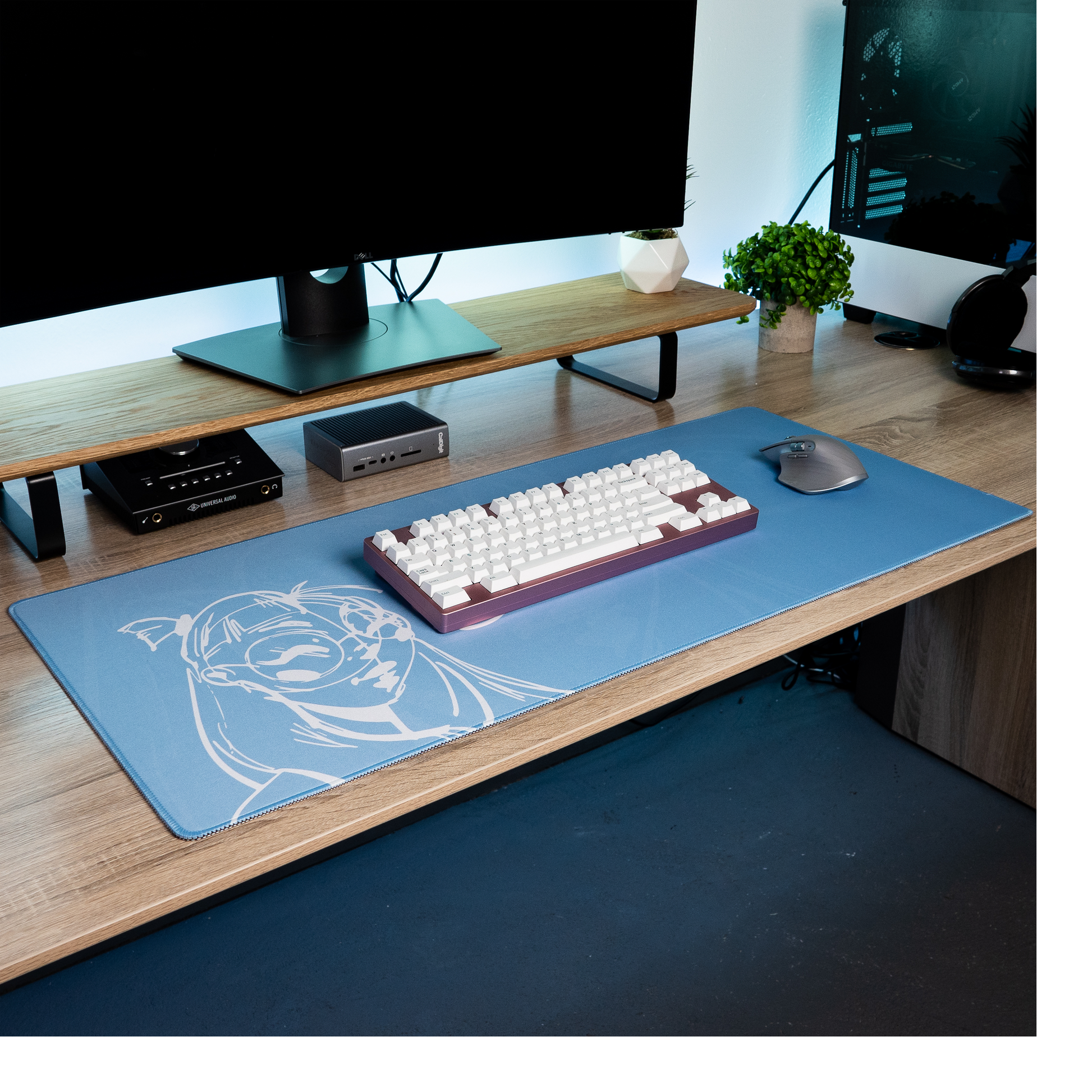 Blue desk mat with white anime-style portrait graphic and gaming icons