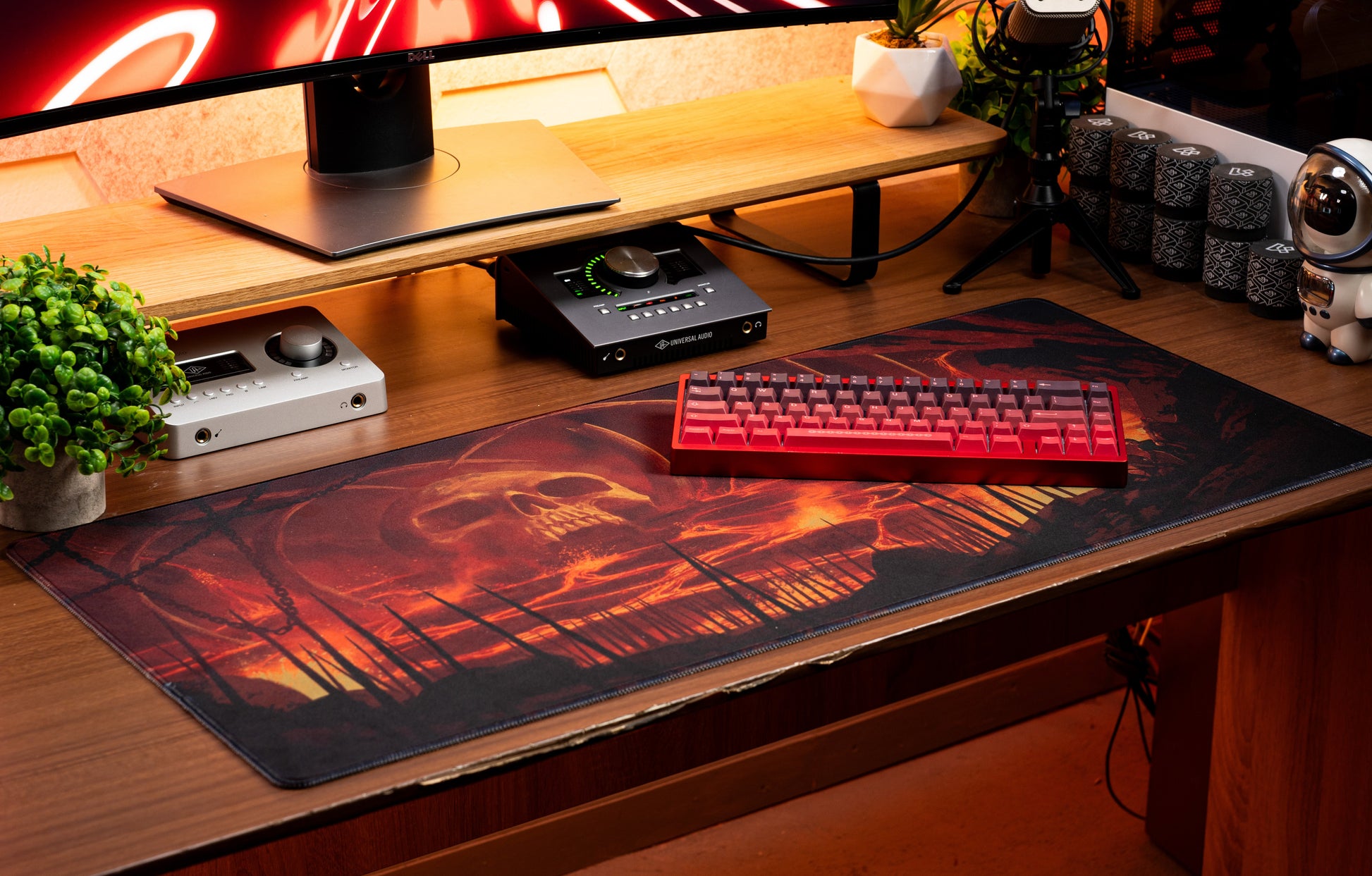 Desk mat with red-orange fire scene and dark silhouettes, stitched edge
