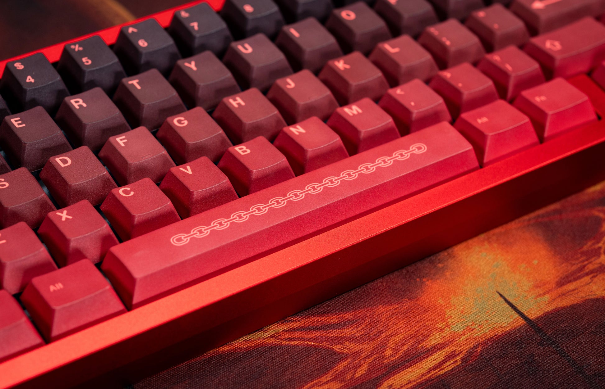 Red PBT keycaps close-up with chain motif on the spacebar