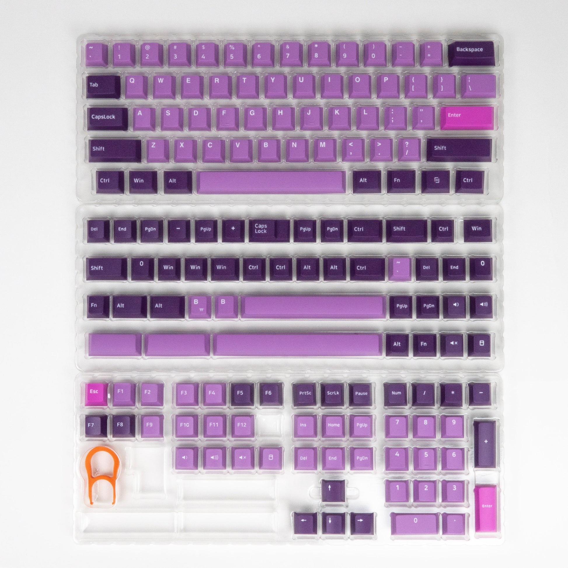 Purple octopus-themed keycaps in a clear tray with assorted modifier keys.