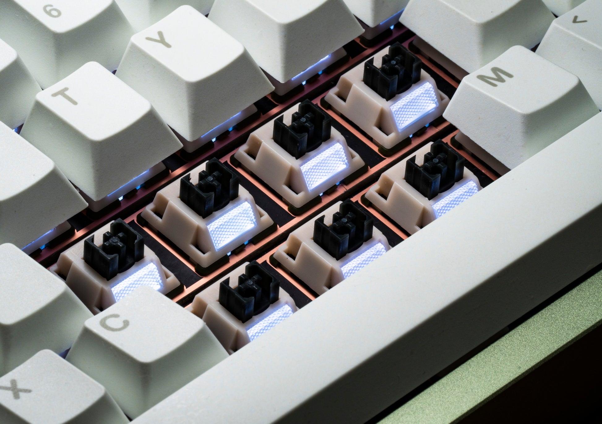 Set of tactile keyboard switches installed in a plate, with illuminated light diffusers