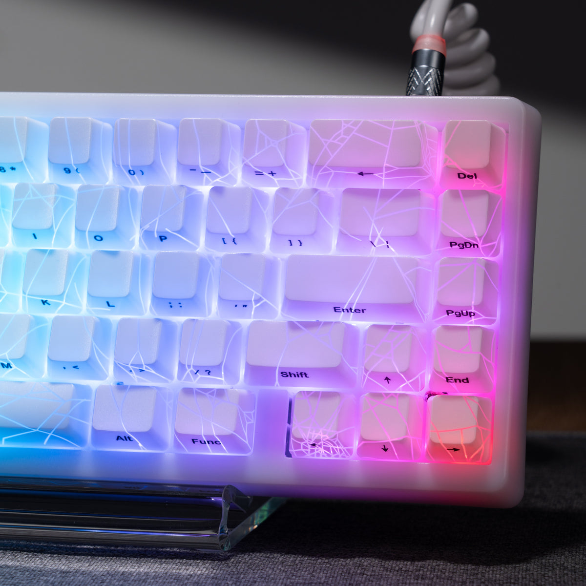 White mechanical keyboard close-up showing RGB-lit keys and labeled switches
