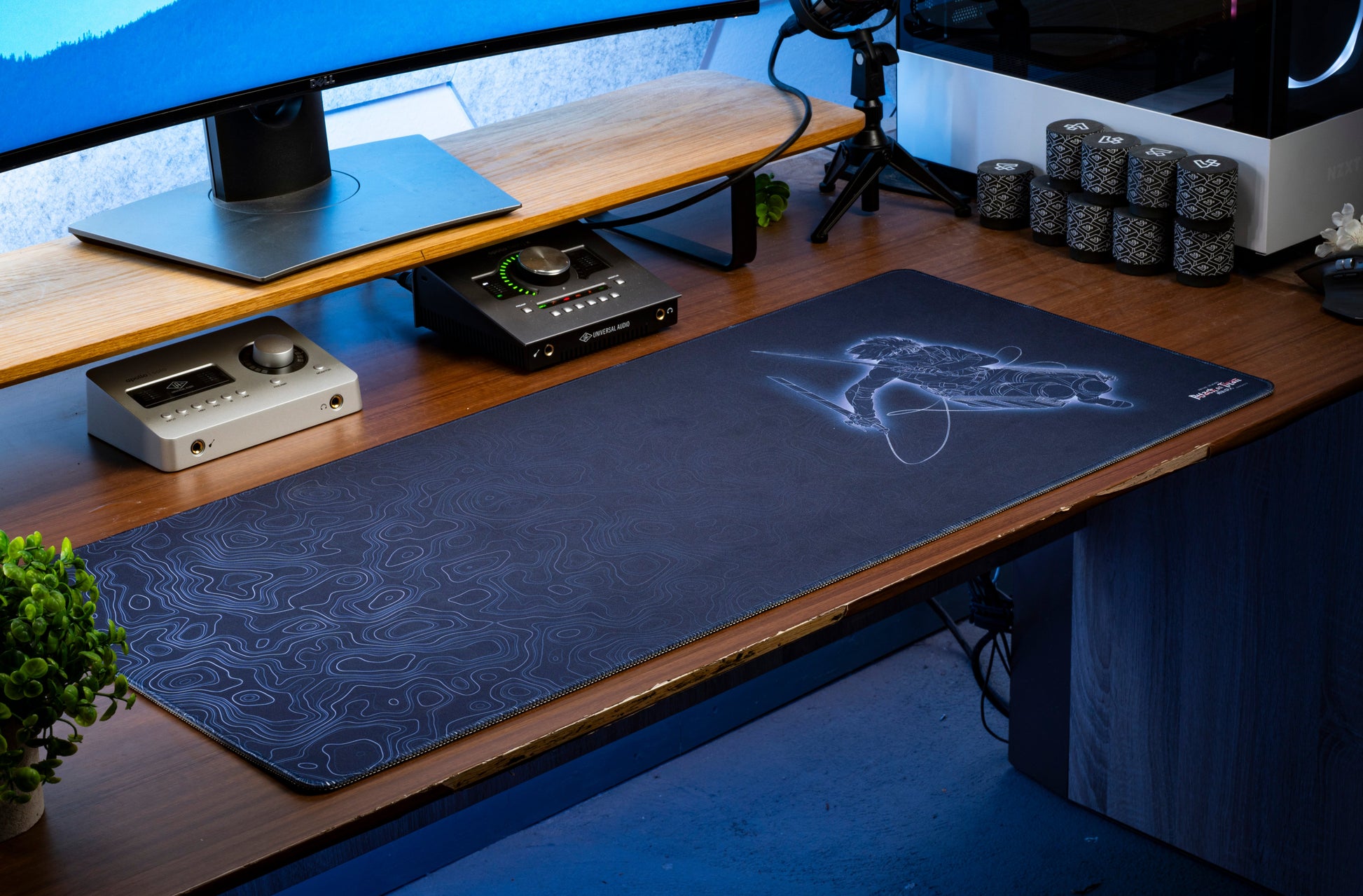 Dark blue anime desk mat with character line art and swirling topographical contour pattern