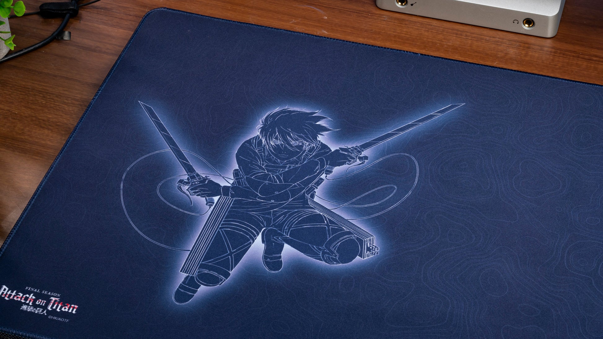 Dark blue desk mat with large swordsman line art and subtle swirl background
