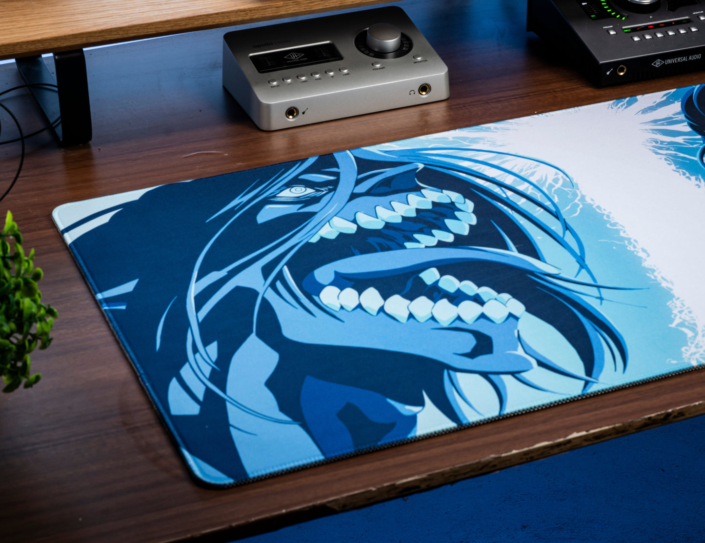 Desk mat with blue-and-white close-up character artwork, flat stitched perimeter