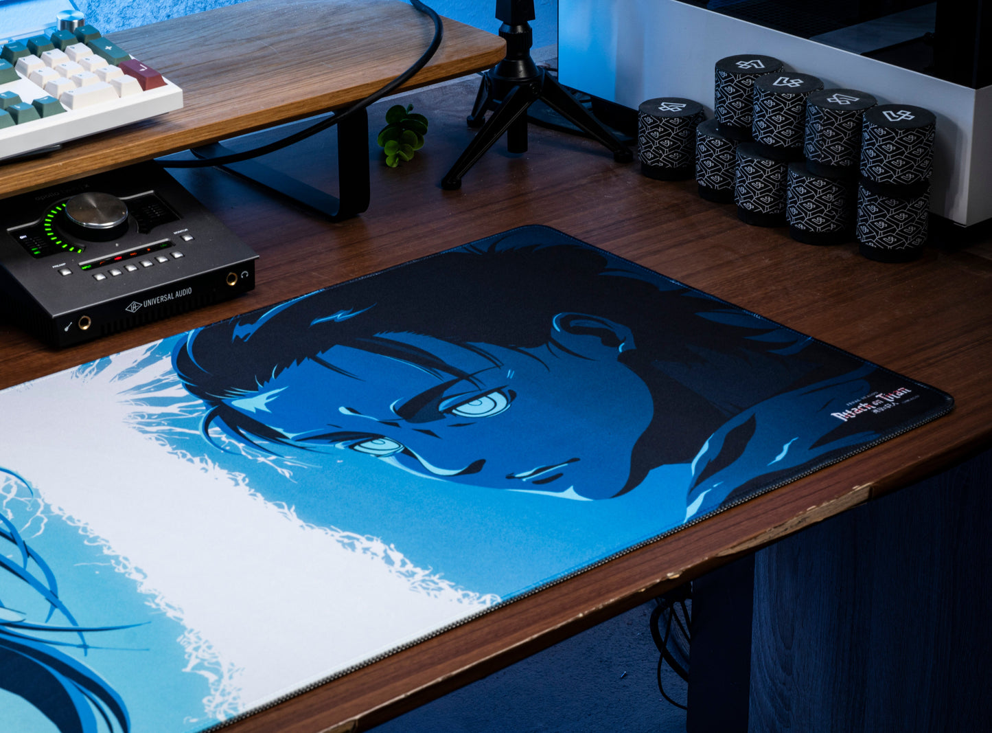Desk mat with blue-and-white anime character face graphic, black border edges