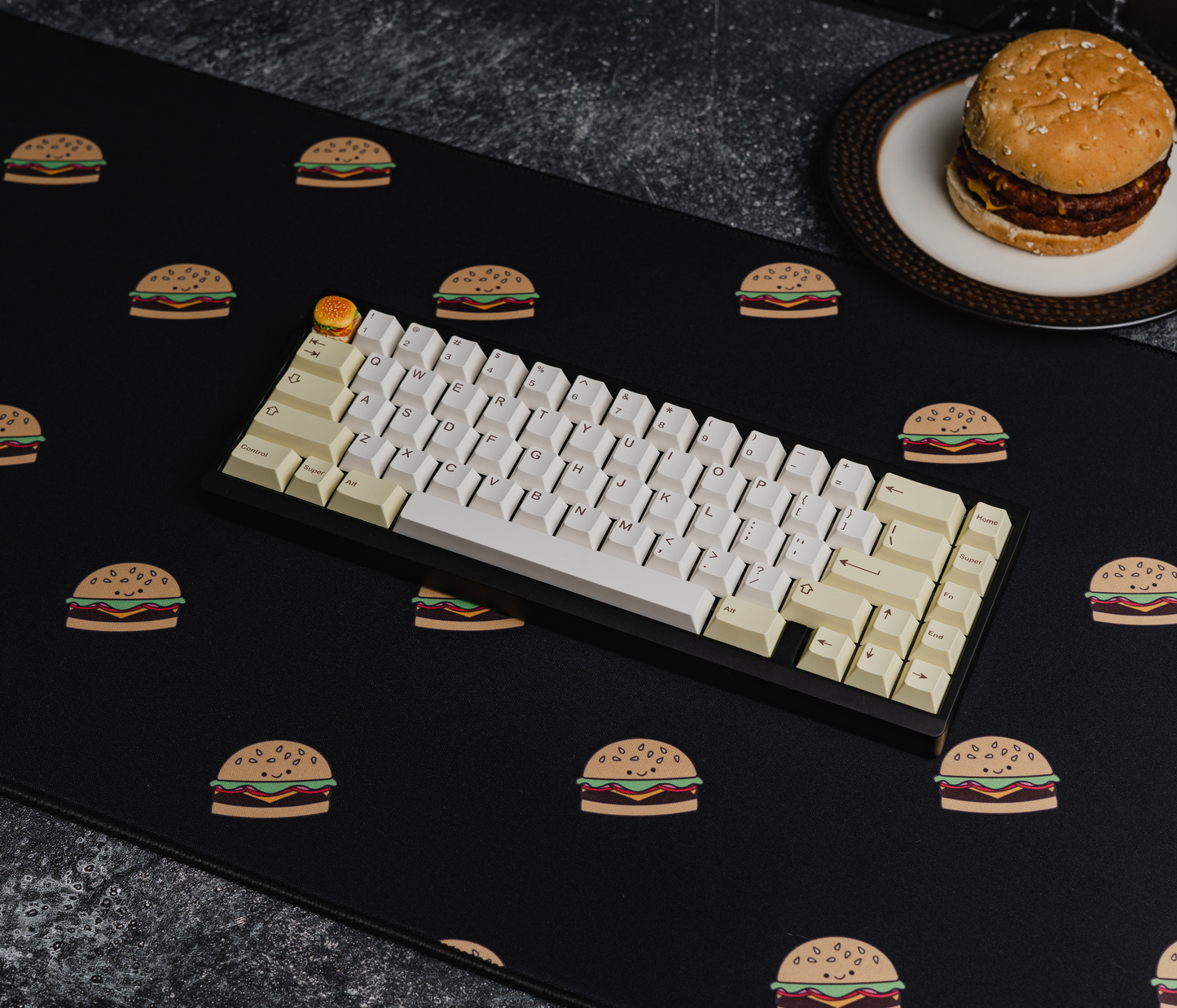 Burger-printed desk mat with black surface and scattered burger icons